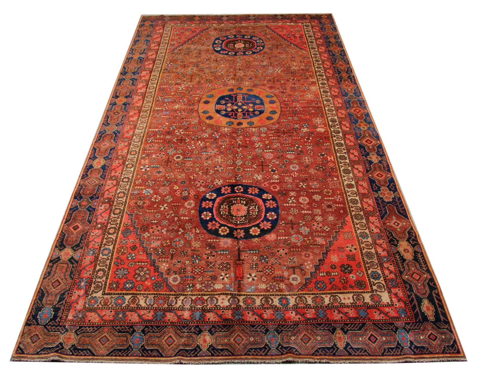 Oriental Carpets from Khotan have a style that is all their own. This orange rug has three beautiful circulars medallions and lots of beautiful historical motives on the rust field. This large rug for sale has a very nice colour combination in the