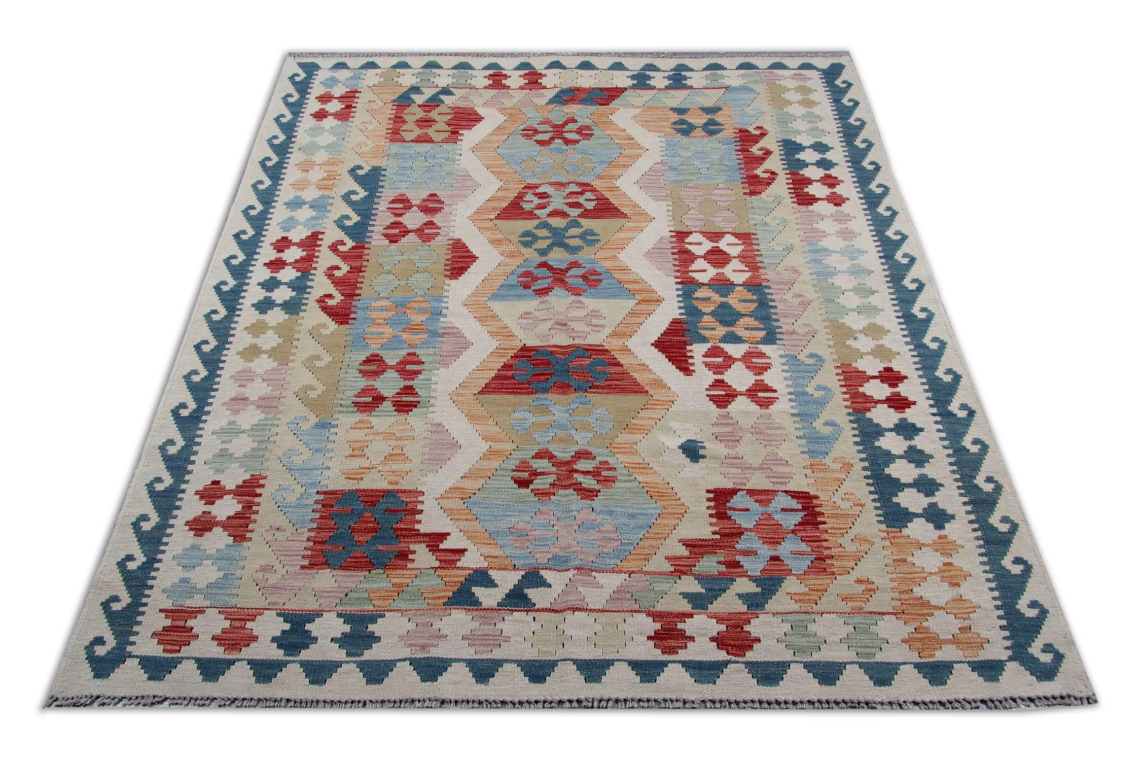 This is an oriental rug example of a flat-weave rug that has been woven by Uzbek and Turkmen tribes in North Afghanistan. This tribal rug was carefully handmade using only wool and cotton. The use of organic dyes is enhancing the quality of this
