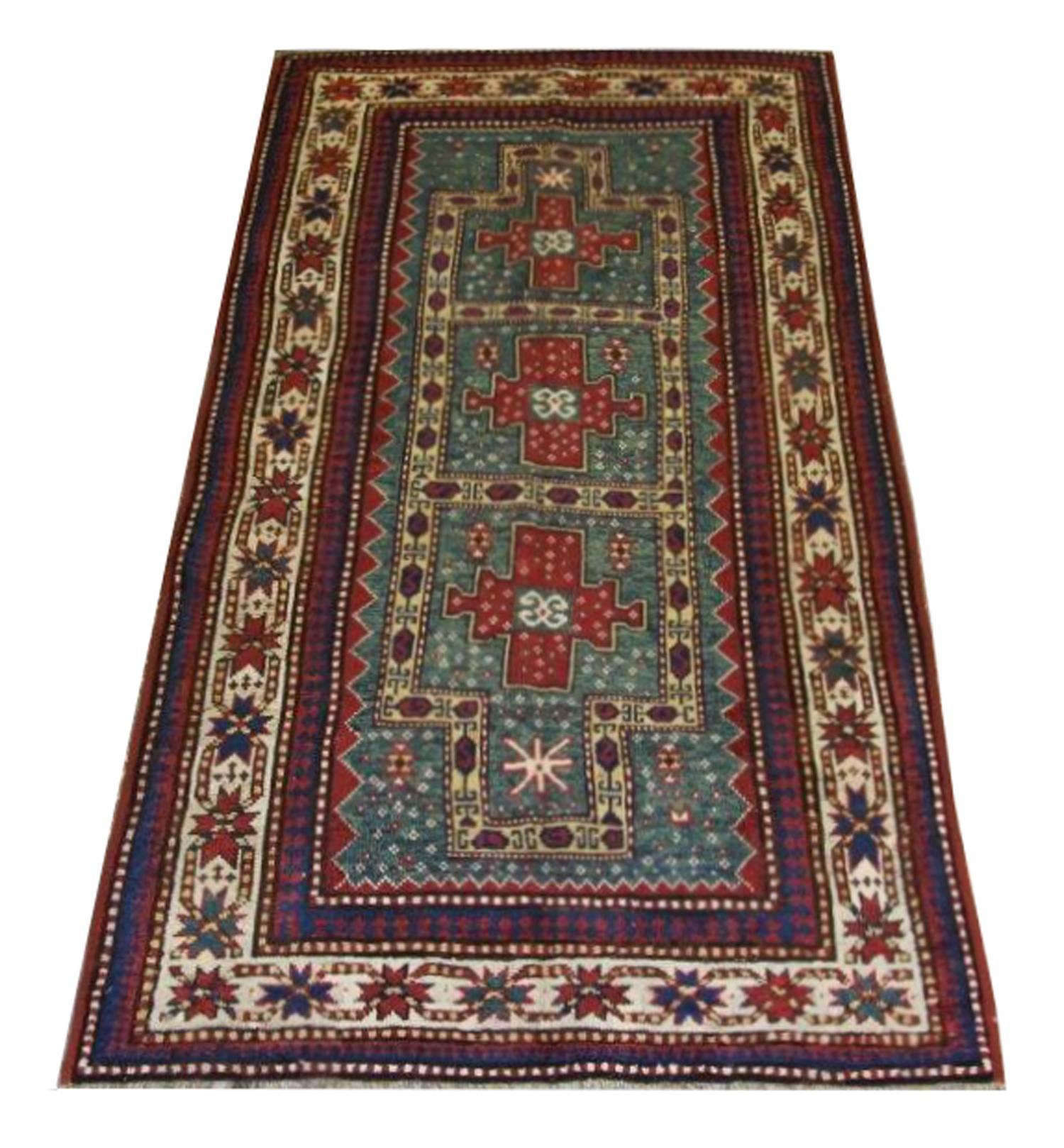 Antique handmade carpet Caucasian Kazak, circa the 1900s, oriental rugs design. The city of Kazak is located on the western republic of Azerbaijan which is famous for producing fantastic Patterned rugs from the 18th century onwards using vibrant