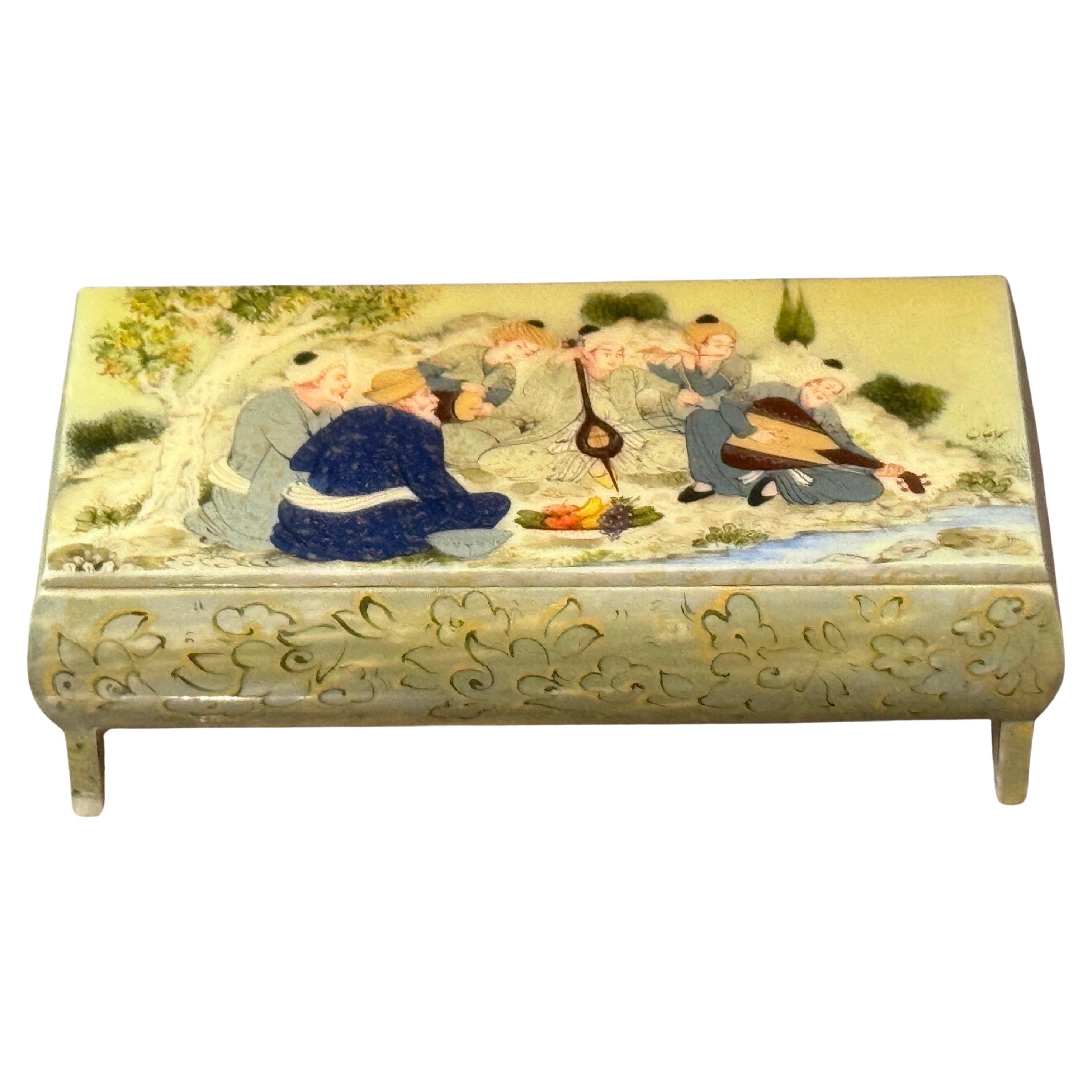 This is a finely hand-painted West Asian miniature artwork on a ceramic/porcelain box, probably made of leg plates, framed, and painted. The work features an extremely fine painting on the hinge cover, with a multi-figure scene in polychrome colors