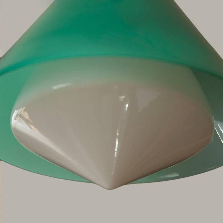 Glass pendant lamp by Peter Pelzel for Vistosi, Italy circa 1961, exterior shade in green glass with white glass interior diffuser, with hardware in brass and enameled metal. Manufactured by Vistosi, Murano.