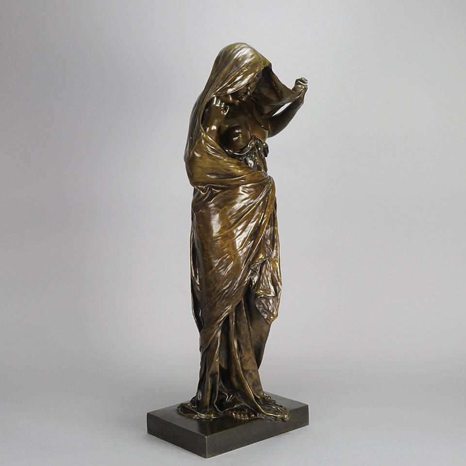 A fabulous Art Nouveau late 19th century French bronze figure of a seductively draped naked beauty representing, in allegorical form, Mother Nature revealing her secrets to Science, a fitting theme for the late nineteenth century. The interest in