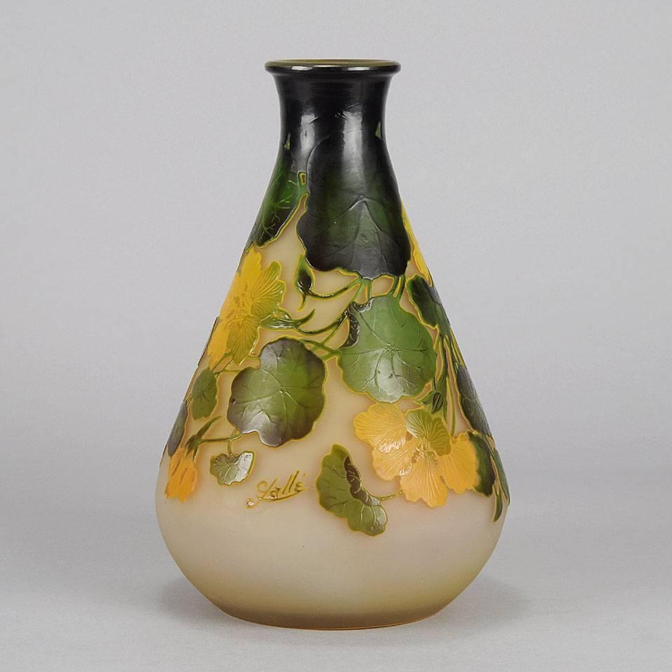 A beautiful late 19th century cameo glass vase decorated with vibrant yellow and green flowers against a deep cream field, exhibiting very fine detail and good color, signed Gallé.
 