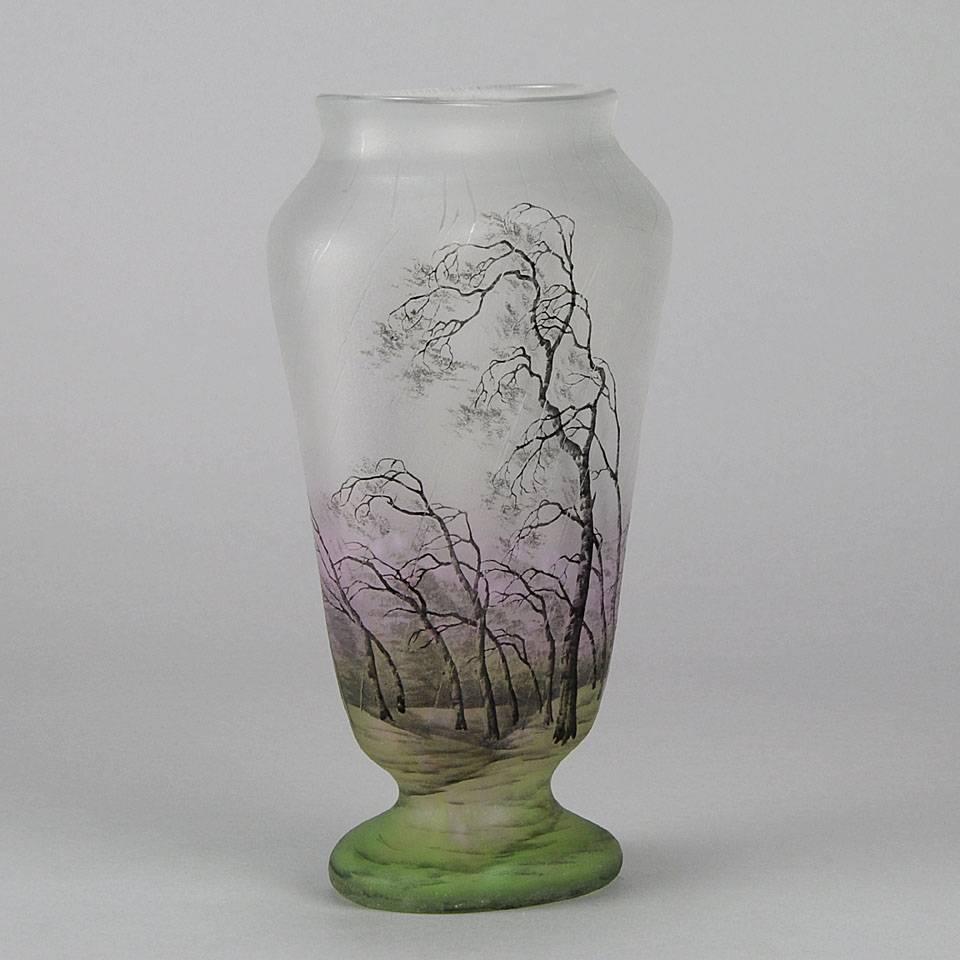 A particularly stunning cameo glass vase etched and enamelled with a landscape of windswept silver birch trees lashed by the rain. The green and pink enamel colors further enhancing the depth of field on this highly decorative and important vase.