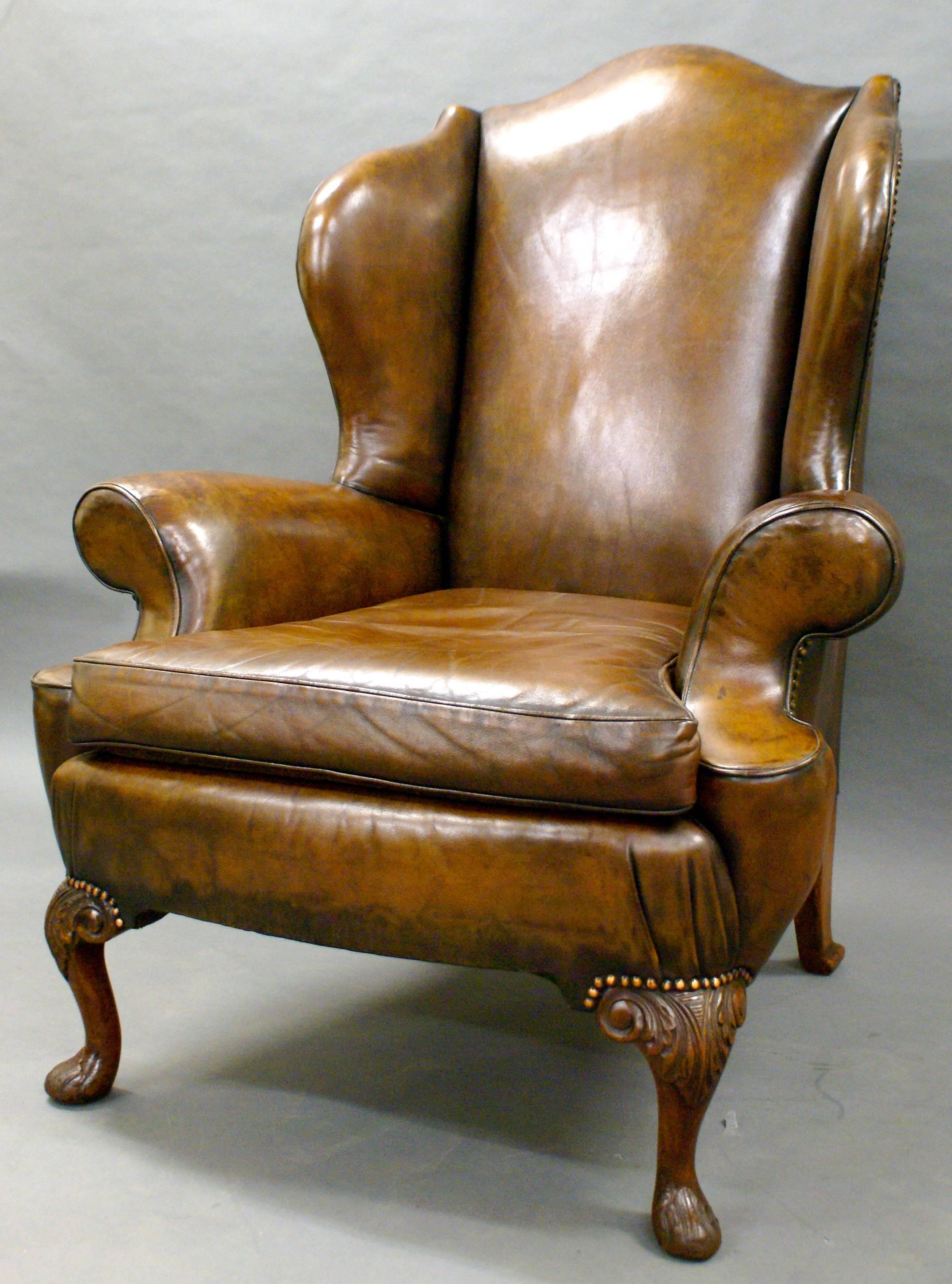 This impressive chair stands on mahogany cabriole legs with pad feet, both of which are carved. The frame is very well shaped with out-swept arms and strongly defined wings and back. The chair and upholstery are in great condition.