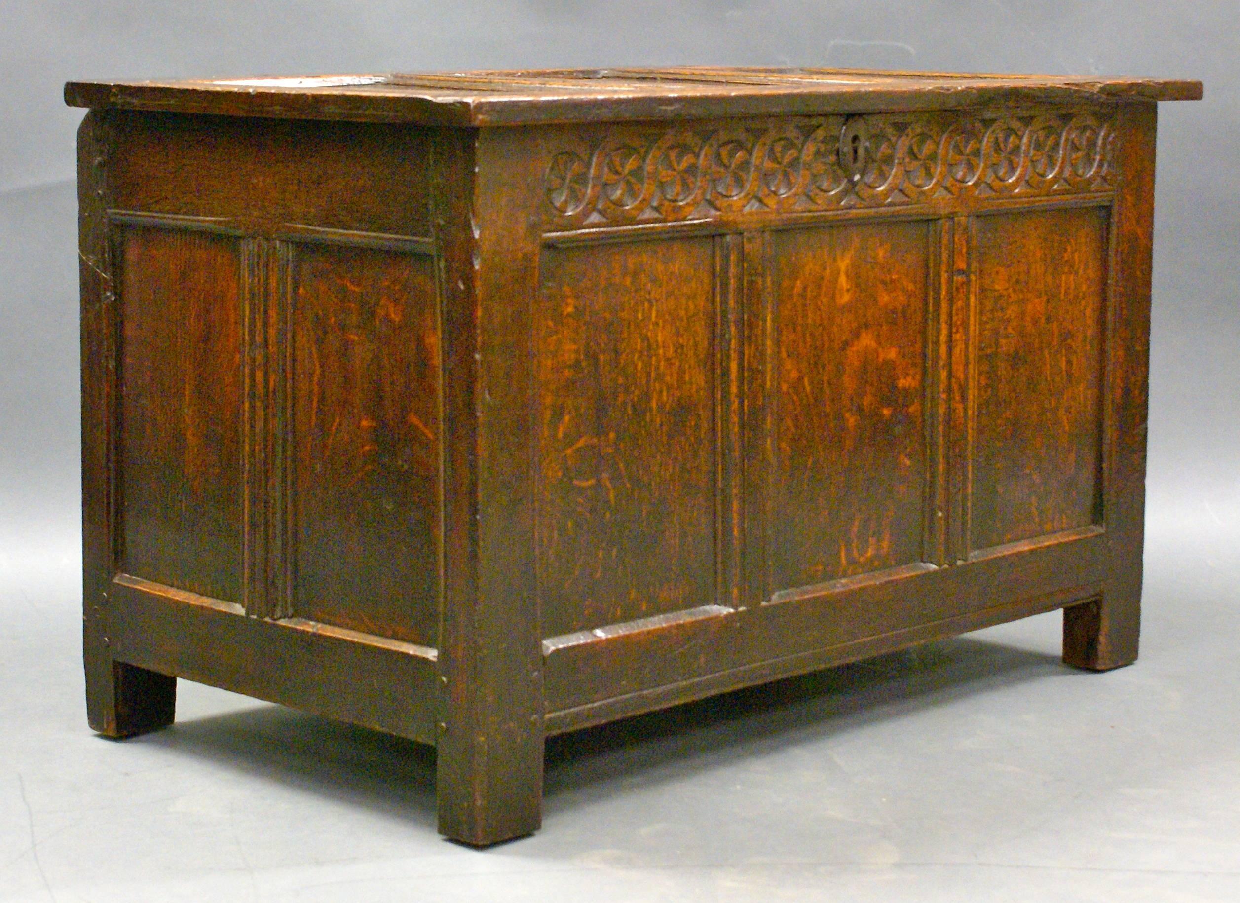 Of small proportions, the hinged lid with three panels, within a channel moulded framework, retains its original two iron butterfly hinges and opens to a lidded candle box to the right side. The front has a guilloche carved frieze. In very good and