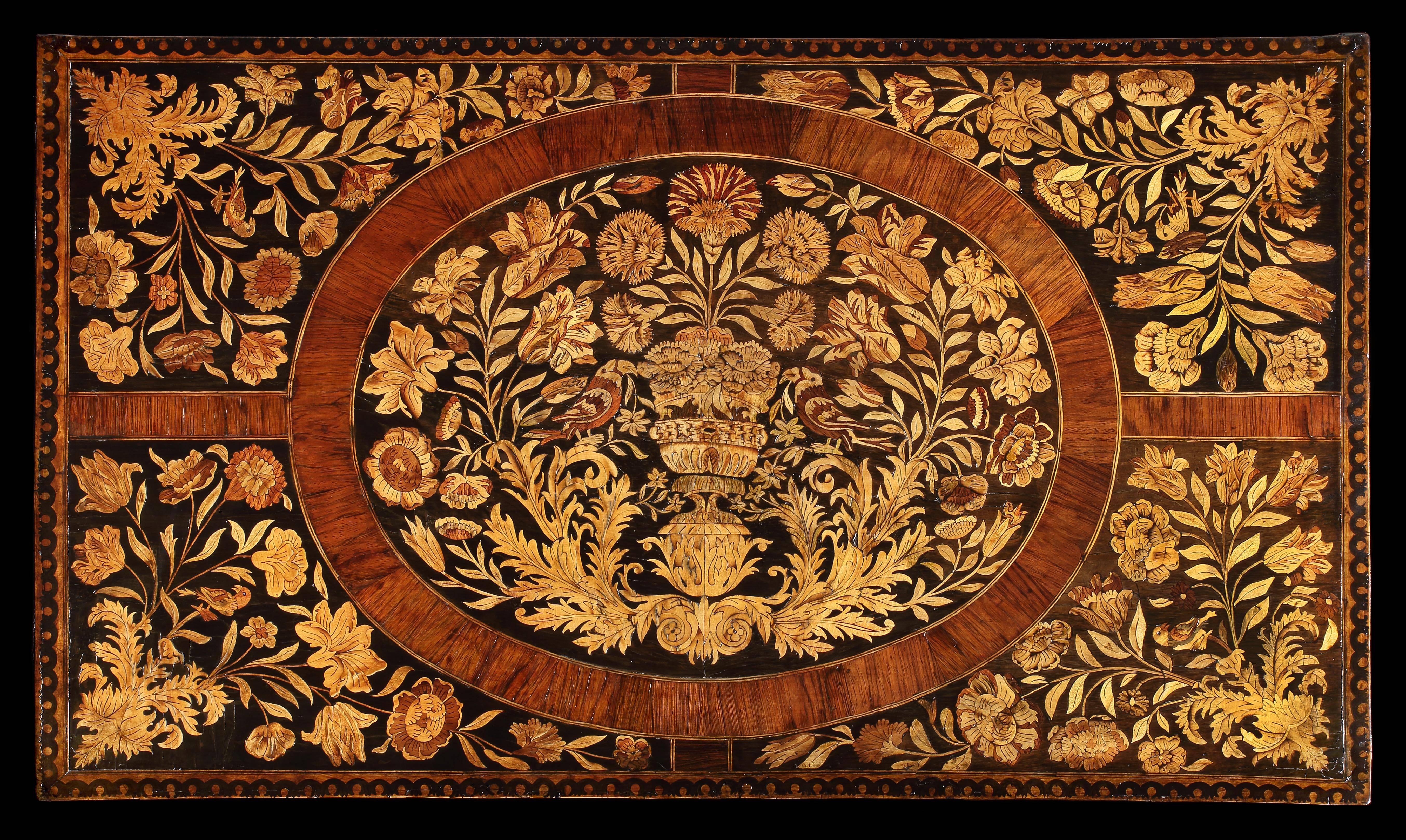 A very fine William & Mary marquetry chest of drawers with elaborate floral marquetry. The rectangular moulded top profusely inlaid with floral marquetry incorporating birds and an urn, with walnut strapwork and inlaid border, the two short and