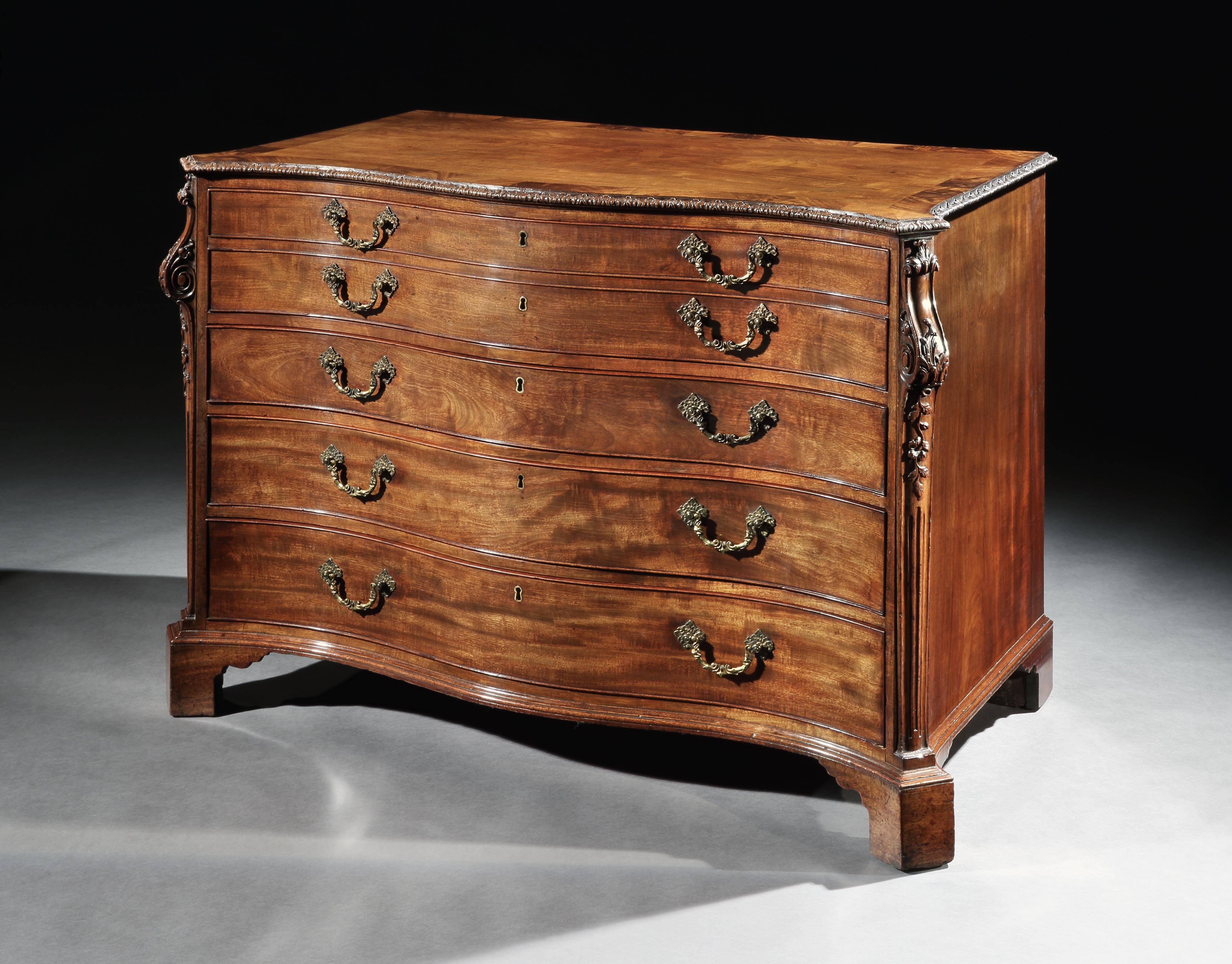 A very fine and rare George III Chippendale period mahogany secretaire-dressing chest of exceptional scale and quality attributed to William Gomm. The shaped serpentine cross-banded top with acanthus carved leading edge, with canted corners carved