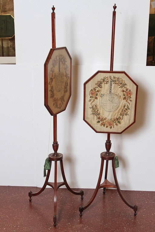 Pair of 19th century Regency silk needlework pole screens in mahogany framework. Original weighted pulley system still functional for raising and lowering.