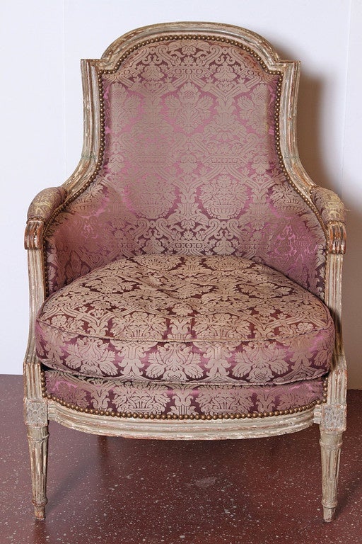 19th century Louis XVI style armchair with red brocade fabric.