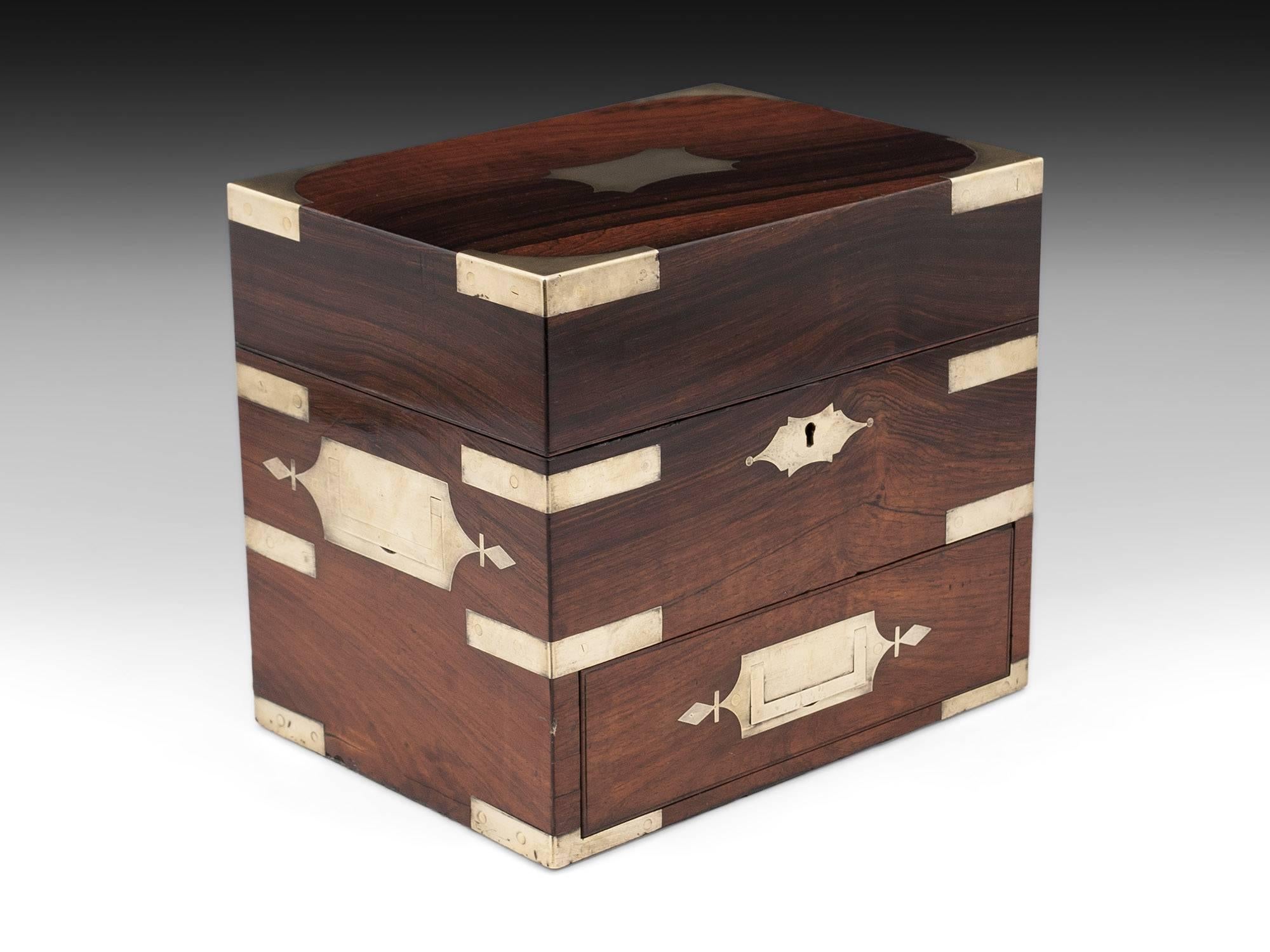 Large Mahogany apothecary box with brass corner brackets for added strength and brass flush carrying handles and drawer pull.

The interior of the apothecary box features 16 labelled glass jars of various sizes, some still with their original