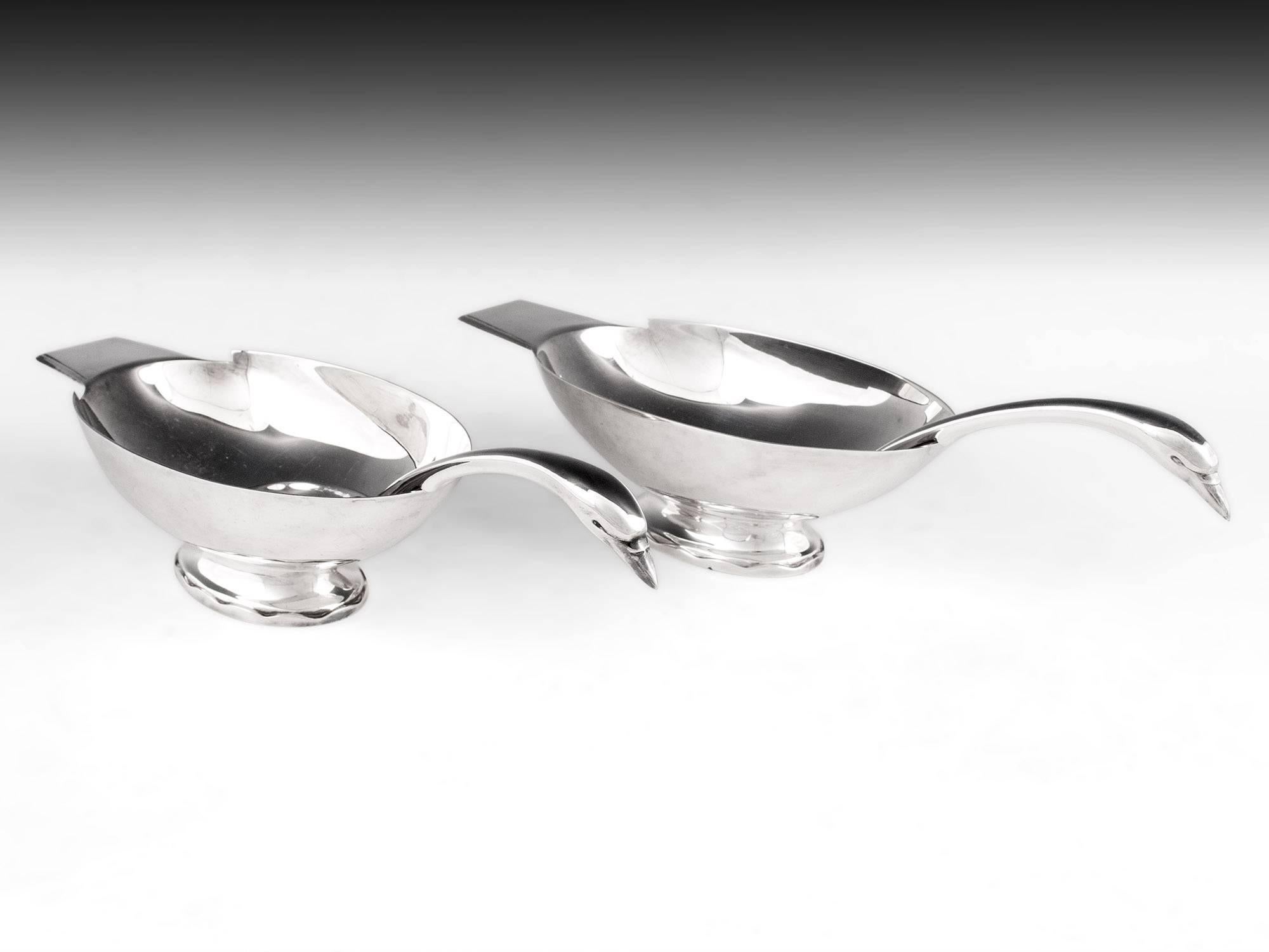 Fabulous pair of Christofle sauce boats designed by Christian Fjerdingstad (1891-1968), a Danish silversmith and design consultant for Christofle, 1924-1939. The oval shaped bowl and fabulous swan neck shaped handle has fantastic balance in the