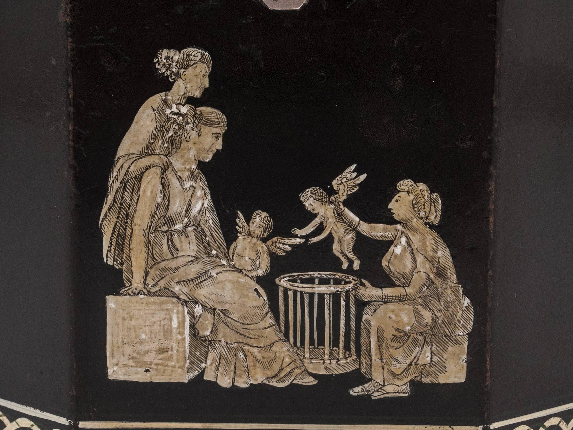 (This tea caddy is currently on display at  “A Tea Journey: from Mountain to the Table” at Compton Verney until the 22nd september.)
Octagonal papier mâché tea caddy, decorated with classical figures and cherubs. Entwined diaper borders which are