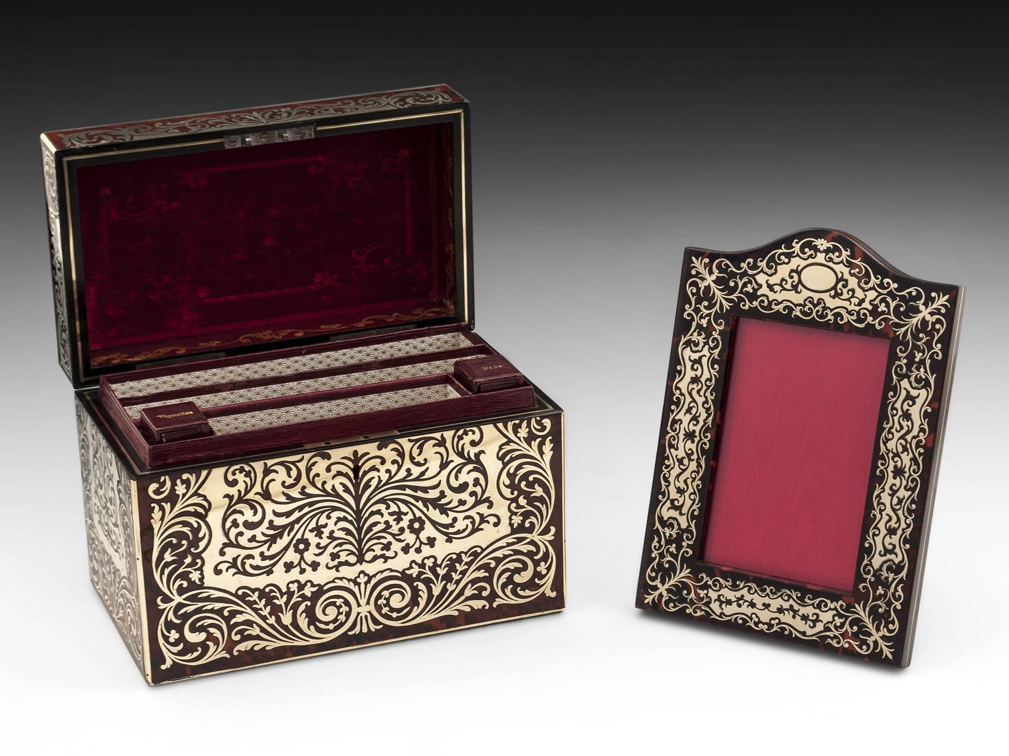 Tortoiseshell boulle desk set by Halstaff & Hannaford comprising a letter box and picture frame. The letter box has three compartments one bearing the label Halstaff & Hannaford, each lined with decorative paper and leather edges. While the