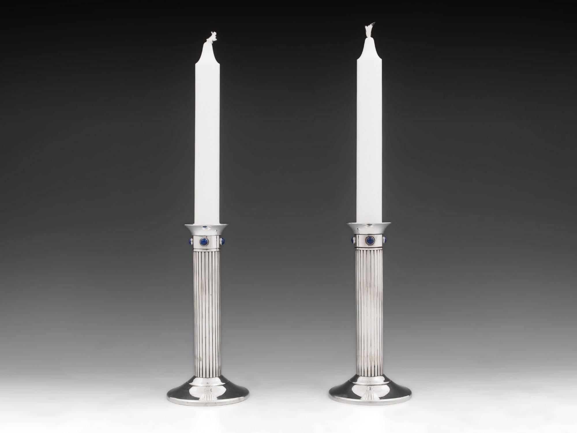 Pair of Silver-plate candle sticks with mounted with beautiful Lapis Lazuli Stones, by Cartier of France. 

The underside of the base is marked: 
Cartier 1989 Made in France.