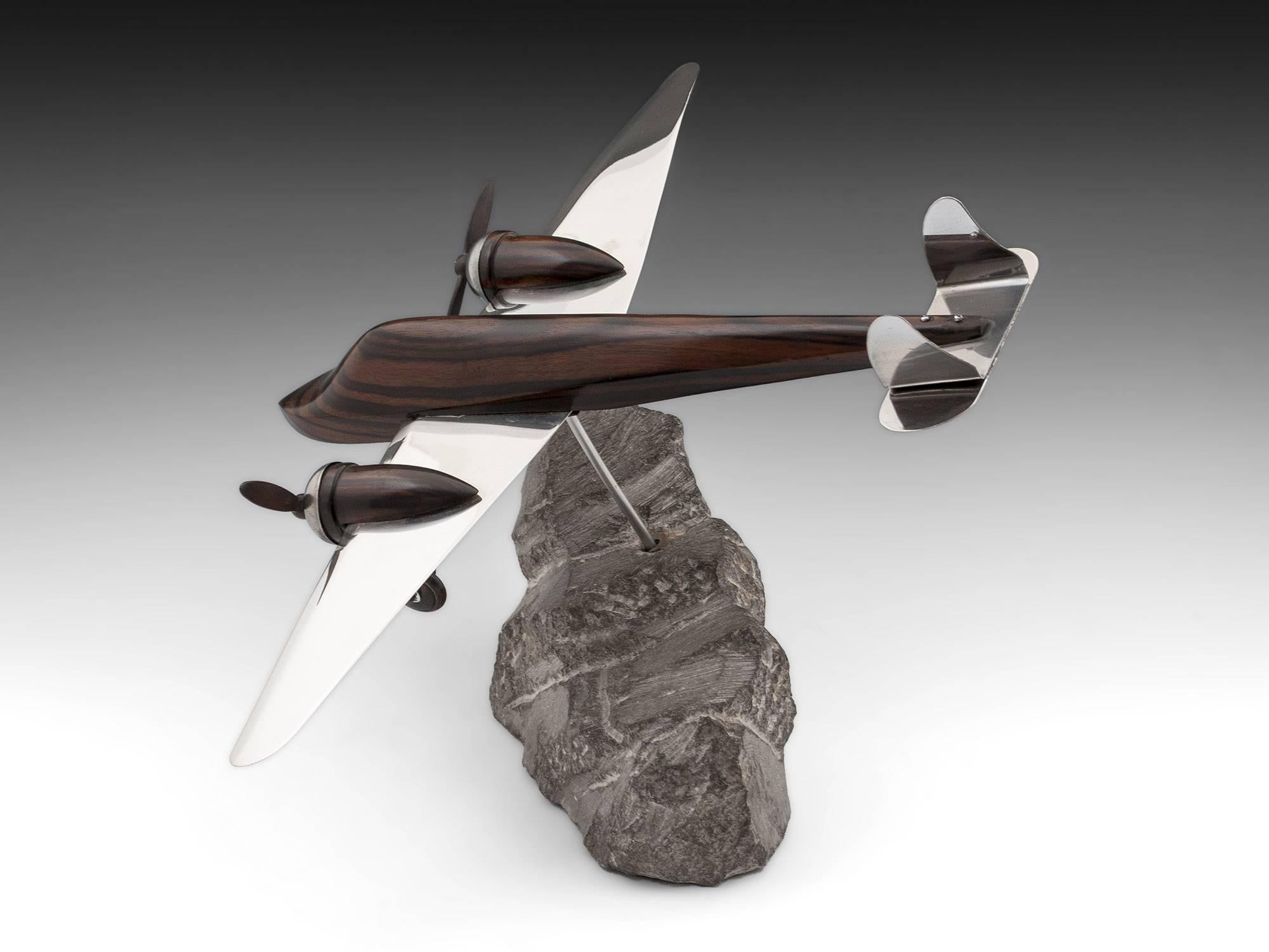 Art Deco Model of an aeroplane made with solid Macassar ebony and silver plated brass. The propellers and landing gear are made of Macassar ebony and both turn. 

Standing on a stone plinth which the plane can swivel on.