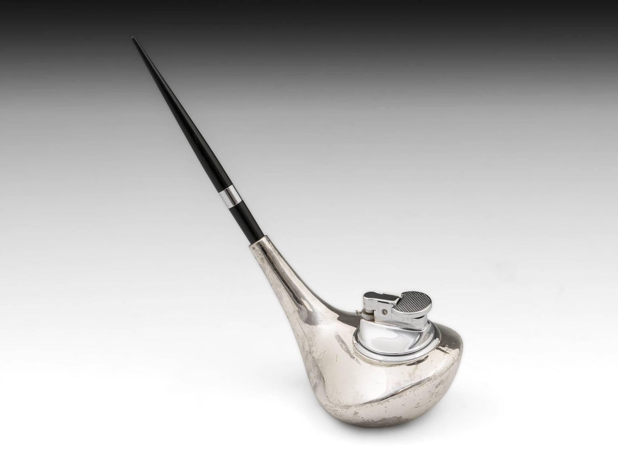 Novelty chrome plated pen stand in the form of a golf club. The gas fueled lighter can be removed for refilling. 

Possible replacement Pen / Biro.