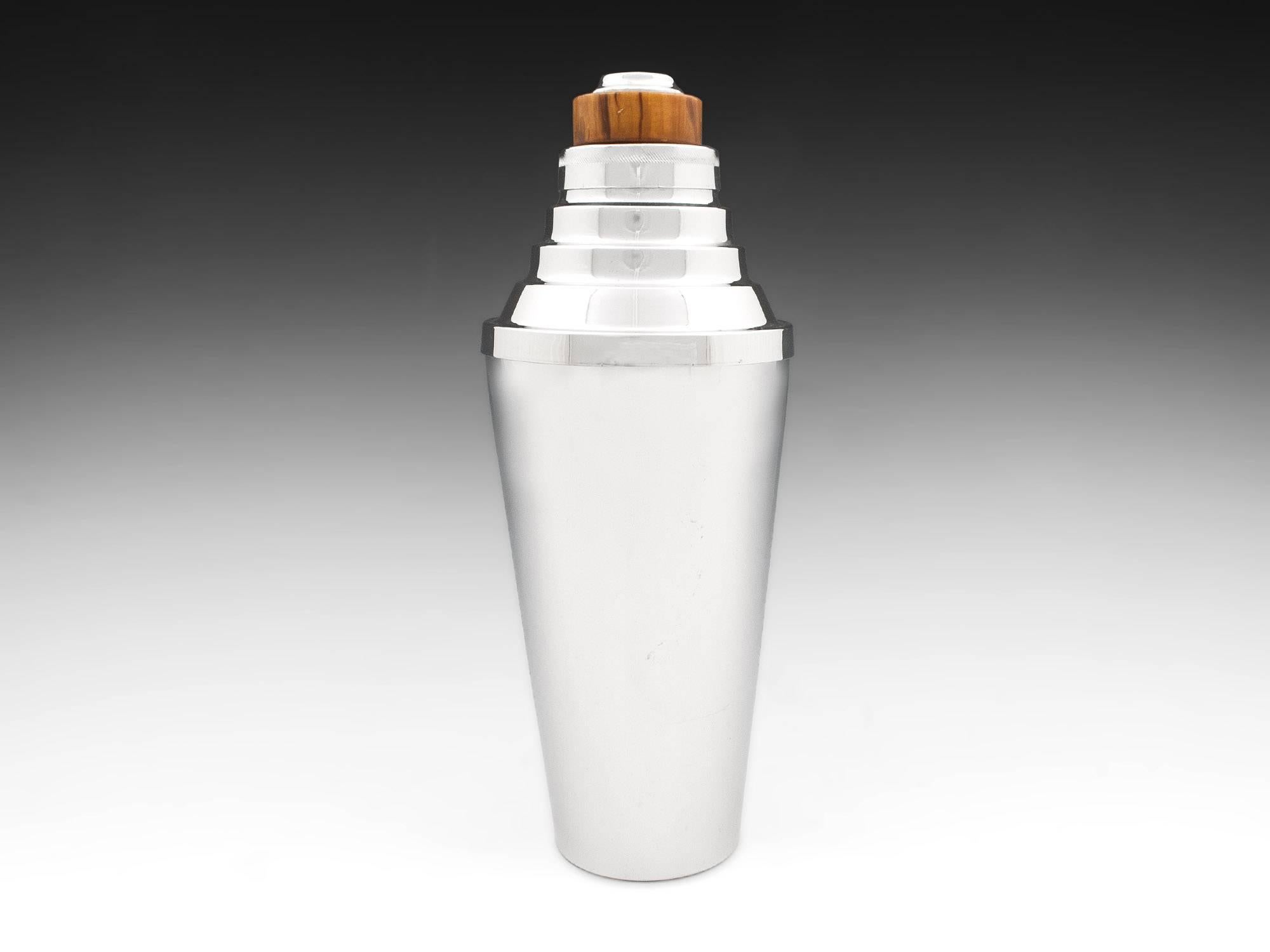 Silver plated cocktail shaker with step shoulder design and bakelite top and silver-plate cap, strainer and collar by Canadian makers Glo-Hill.