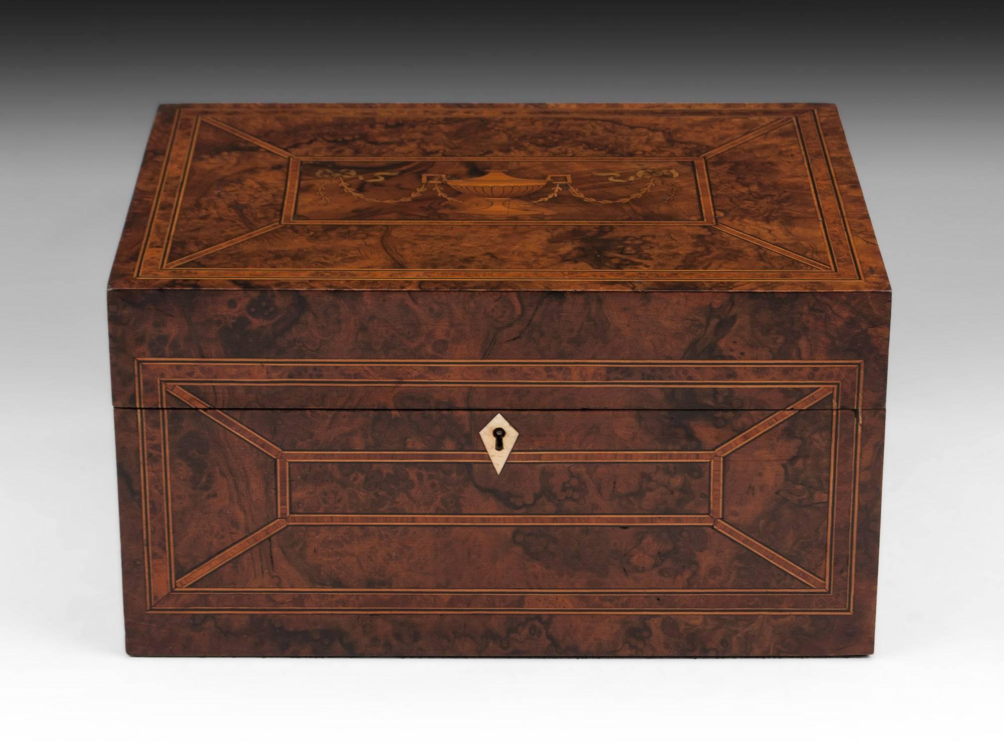 Antique burr walnut Jewelry box with decorative tulipwood crossbanding divided by ebony and boxwood stringing, as well has each panel being framed with Amboyna inlay. The top is adorned with a beautiful inlaid Robert Adam style urn with floral