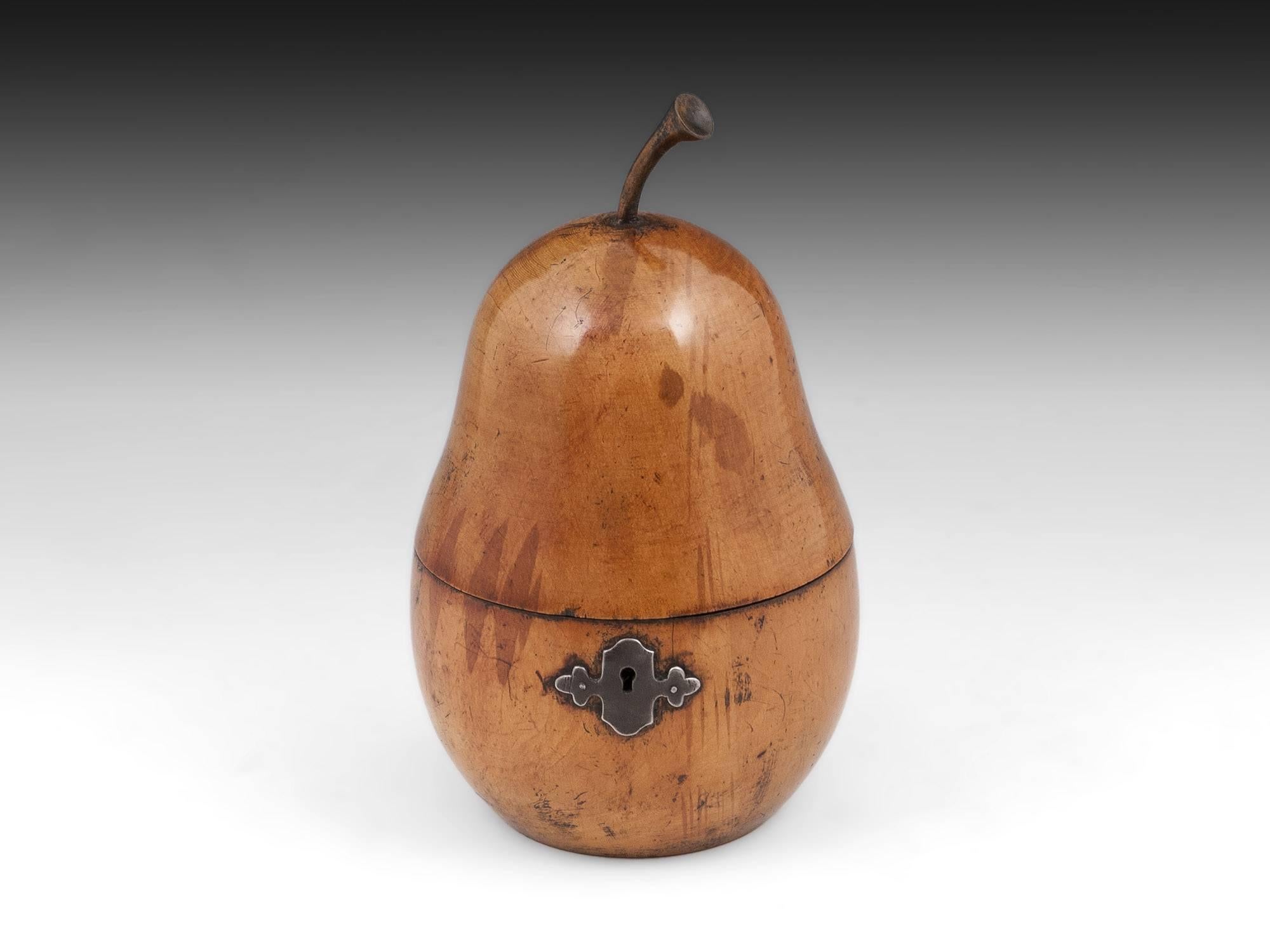 Pear tea caddy with fabulous now very much faded red stained blushes around its body. The wonderful wooden shaped stalk on the pear is very realistic, to the front its has ornate cut steel escutcheon. 

The pear tea caddy interior has been