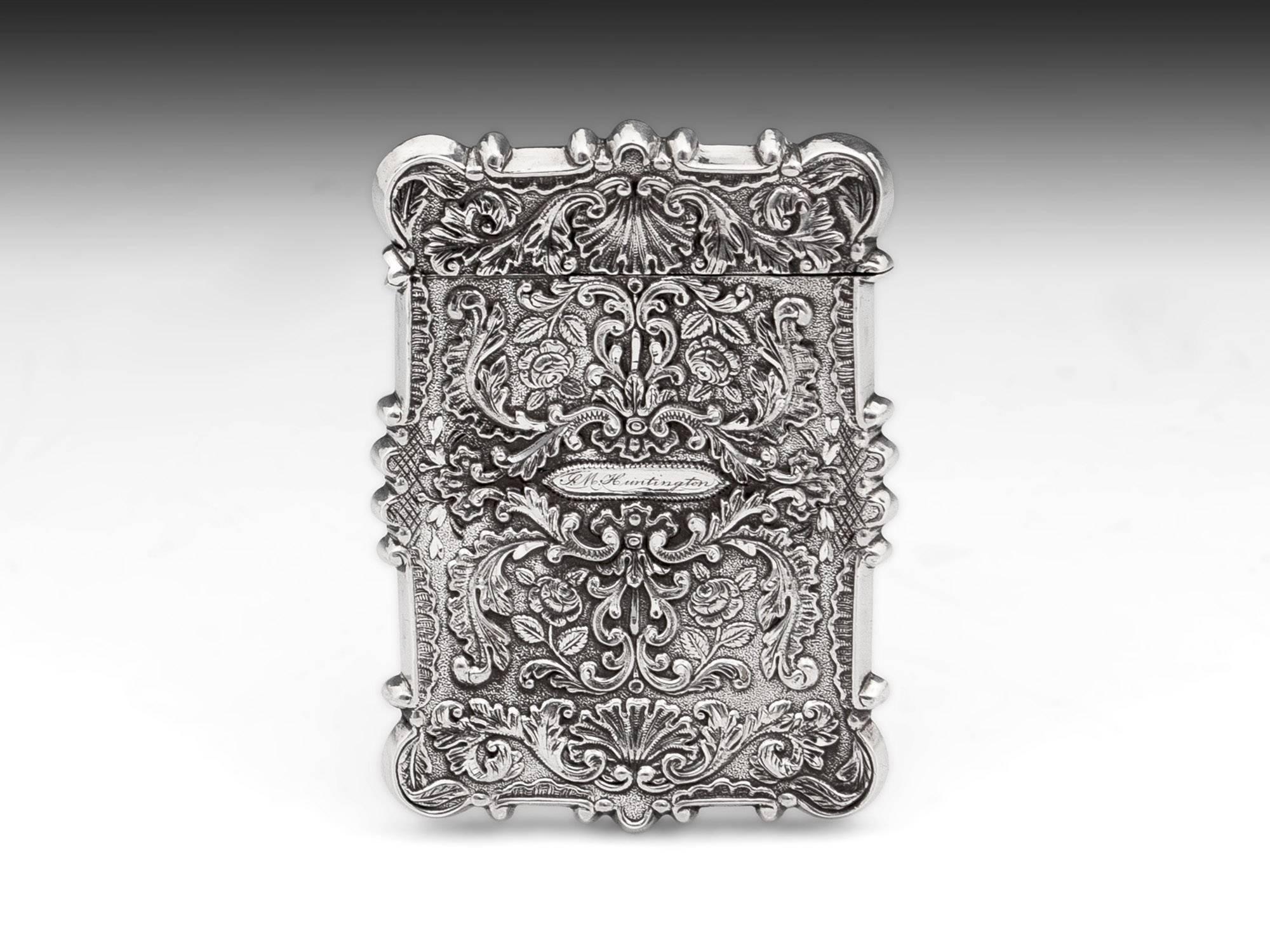 Silver card case by American silversmith Leonard & Wilson. With an intricate quartered floral design on one side and a view of Trinity Church, Wall Street, New York. 

The American card case has a floral design surrounding a name plaque which is