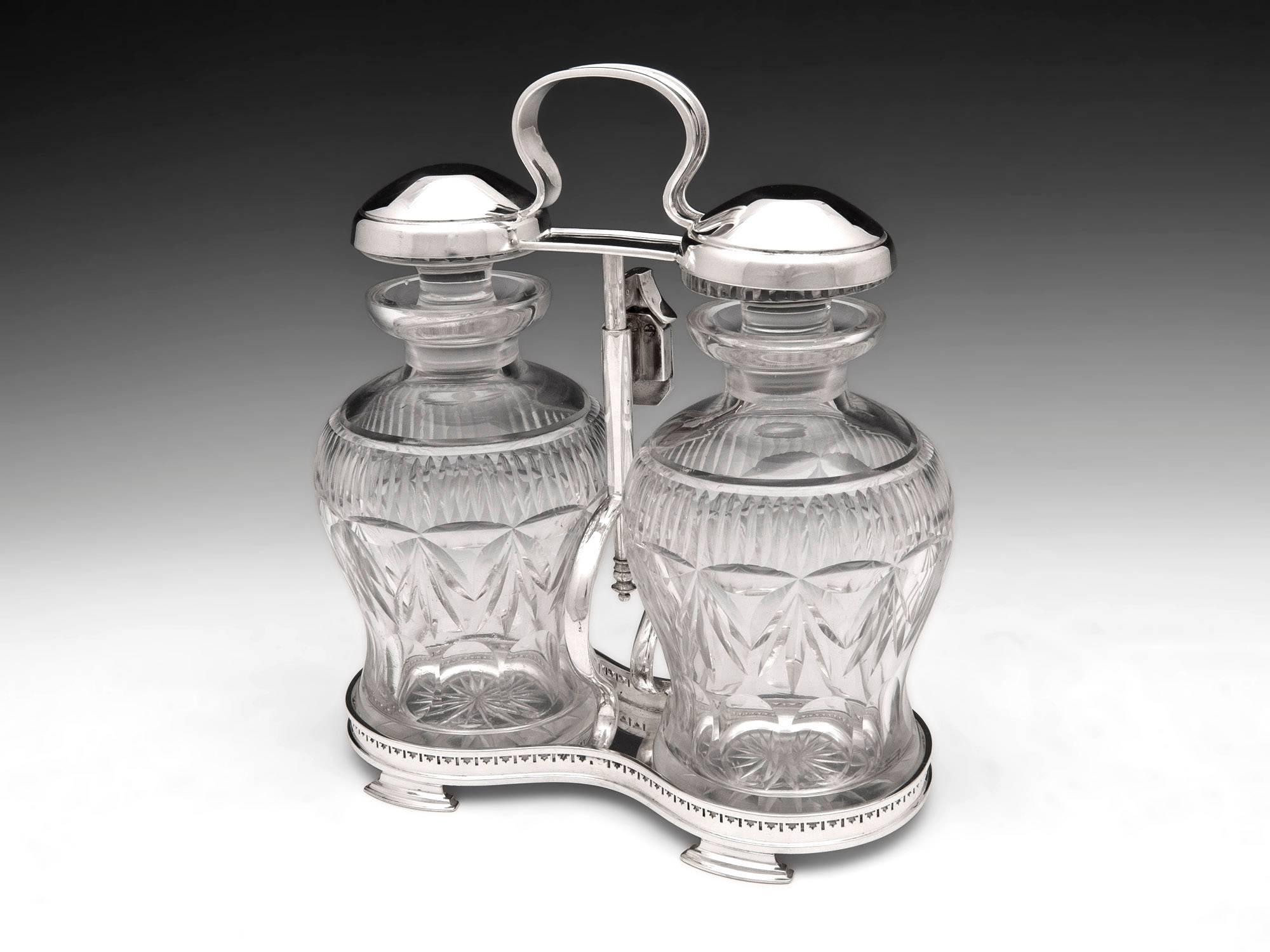 Silver plated Tantalus with two fabulous cut glass decanters.

The decanters are released by unlocking the handle which will spring up and can than be rotated to allow access to the decanters.

This tantalus comes with a fully work lock and