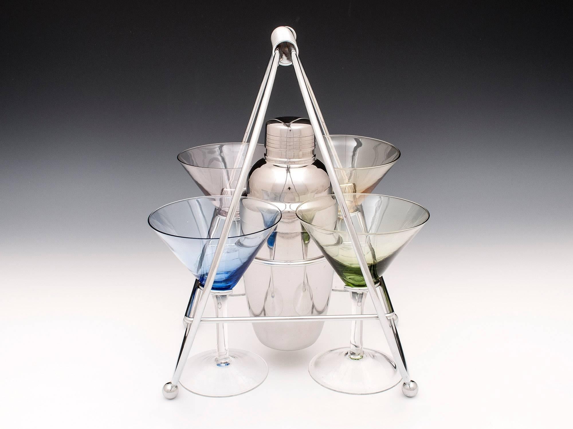 Vintage cocktail set with four coloured cocktail glasses, stainless steel cocktail shaker and chrome carrying frame. 

Cocktail shaker Dimensions: 
Height: 7.75' 
Diameter: 3.5' 

Shipping Cost: 
United Kingdom £25 
Europe £65