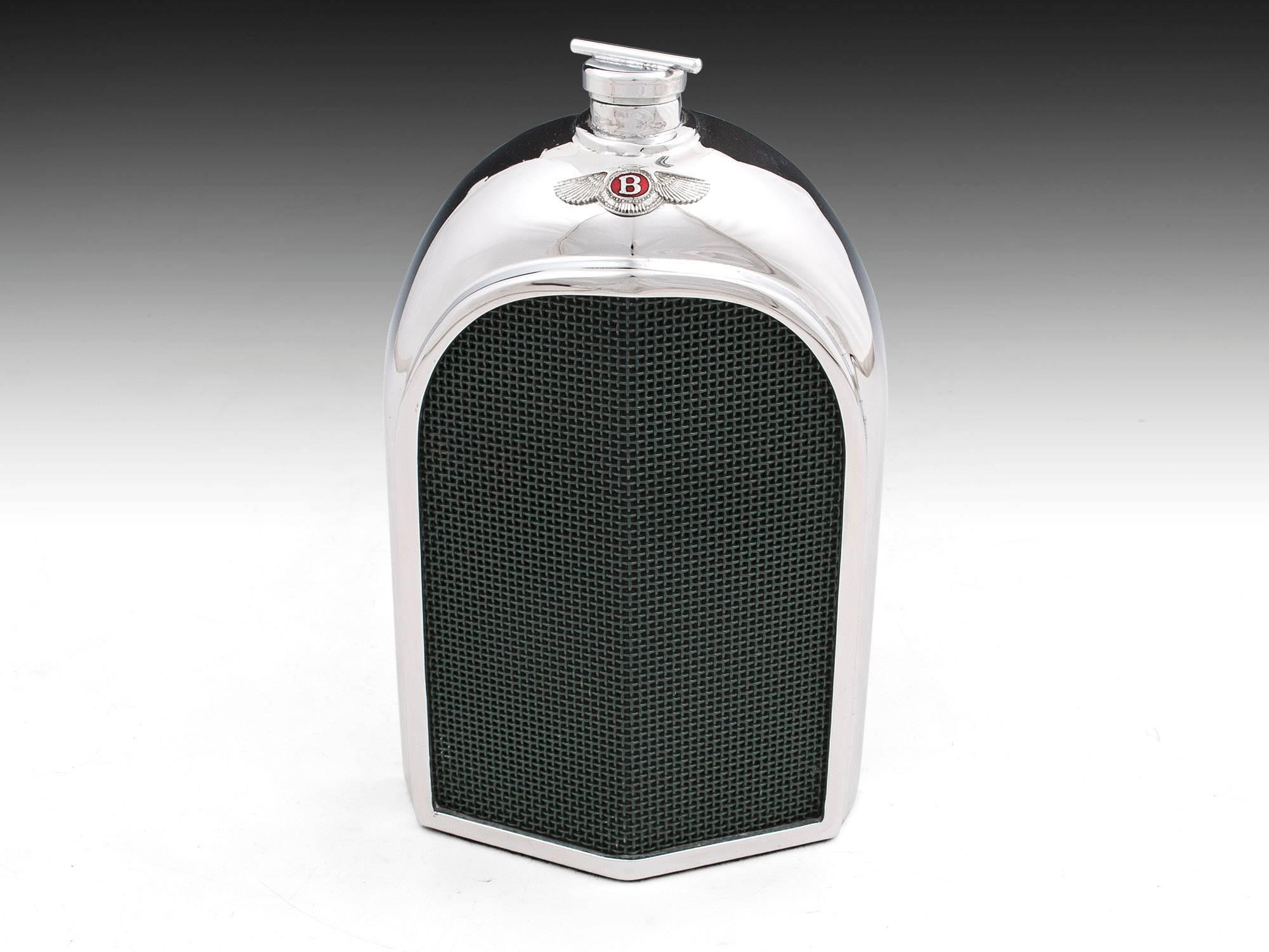 Stunning Bentley radiator spirit decanter. Heavy chromium plated metal around a glass container with green mesh grill. 
There is a slot at the back to view its contents and a baize cloth on the base. 
The small red enamel Bentley badge and screw