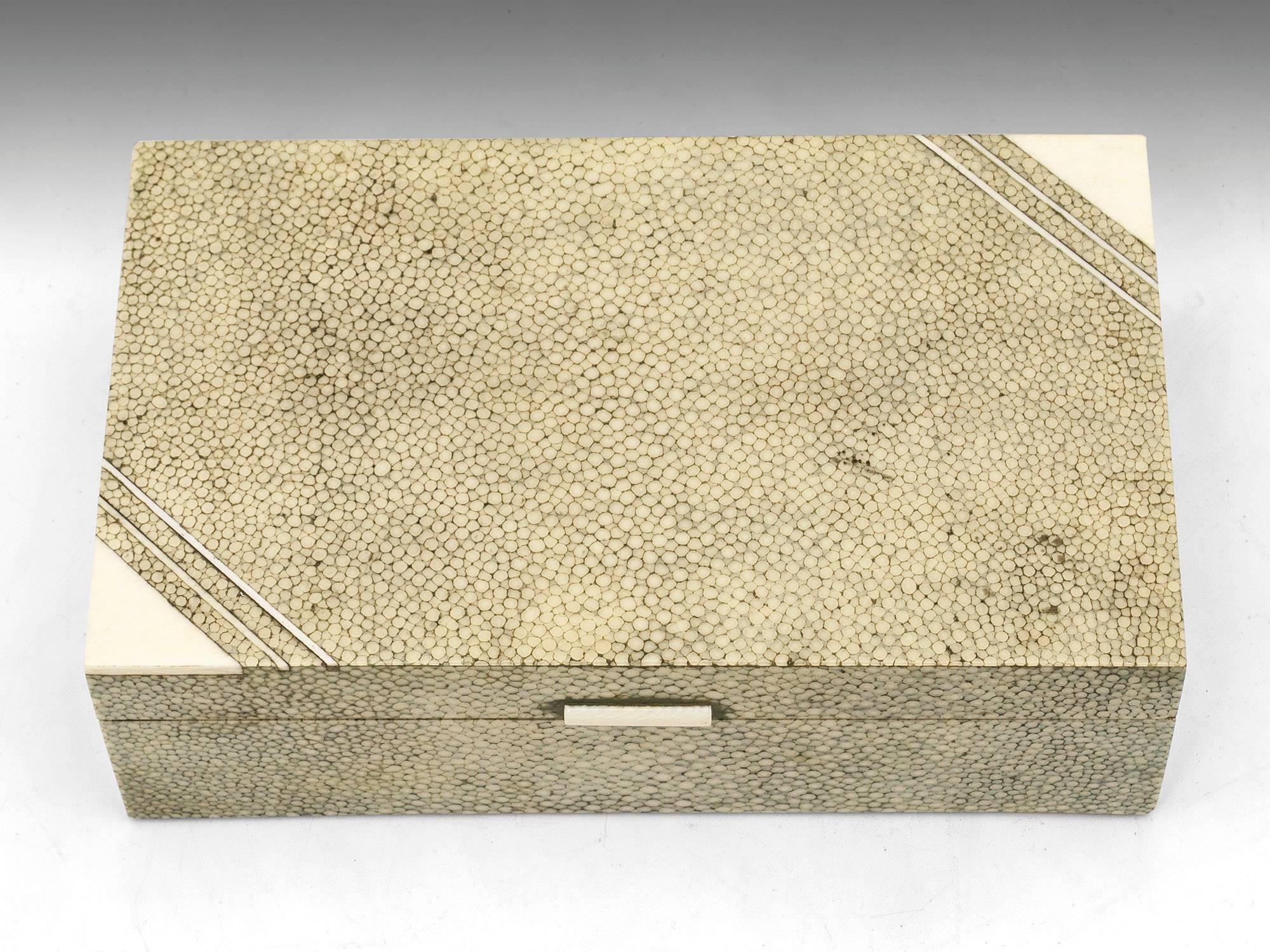 Art Deco shagreen cigarette box with ivory stringing and corner accents. 

The interior is lined with cedar wood and features a removable compartment divider. 

Shagreen is a leather made from sharkskin or the skin of a stingray. This type of