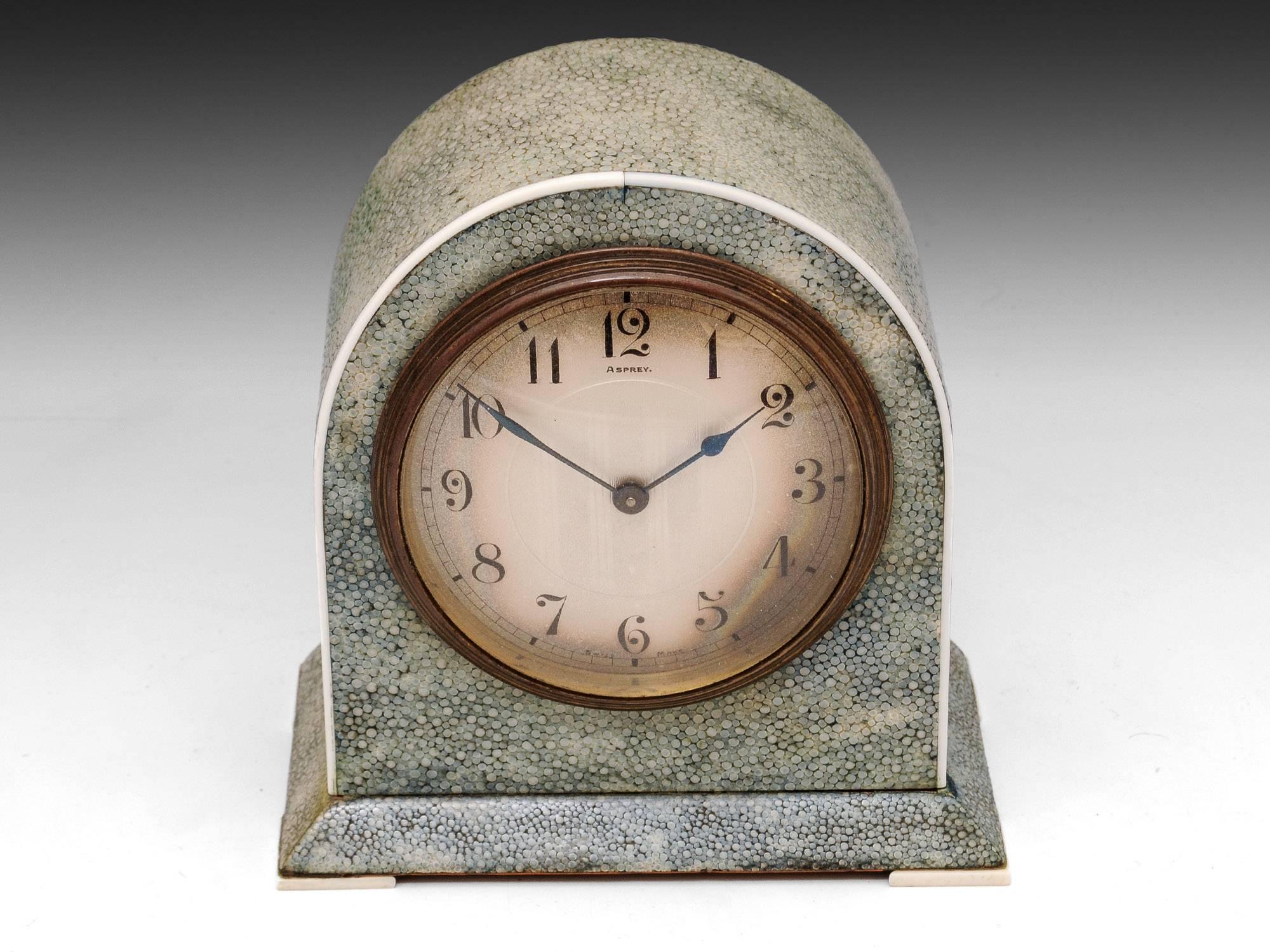Art Deco shagreen mantel Clock by Asprey with French eight day movement. 

Featuring ivory edging and feet and a brass framed clock face. 

Shagreen is a leather made from sharkskin or the skin of a Stingray. This type of Shagreen was first made