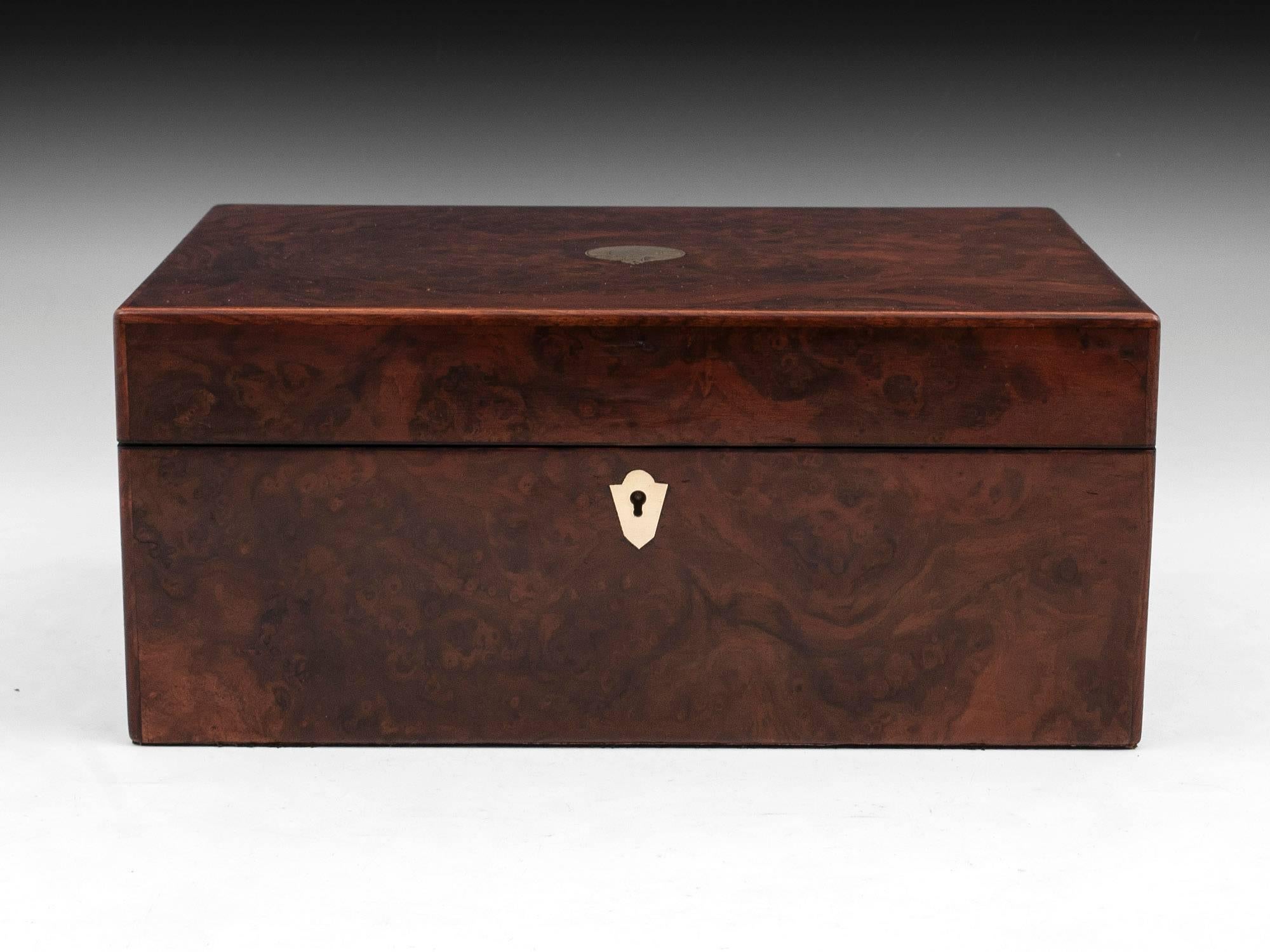 Antique burr walnut jewelry box with brass escutcheon and initial plate. 

The interior is lined with black silk and velvet. Featuring a removable tray which contains several compartments including two for rings, earrings or cufflinks. Underneath