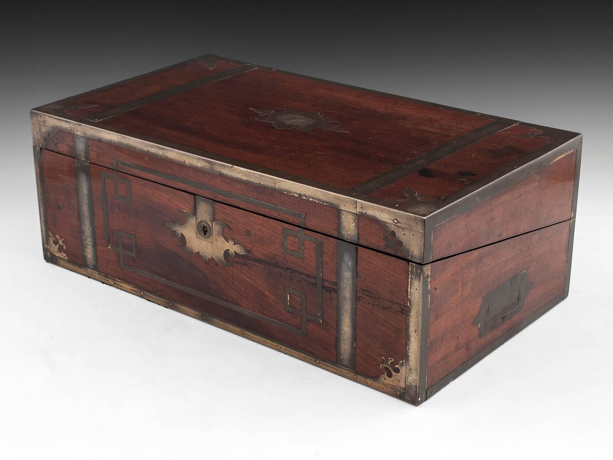 Military writing box with made of solid mahogany with brass stringing, edging, ornate initial plate and flush fitting Campaign carrying handles.

The interior features a replacement black leather and gold tooled writing surface, a brass top