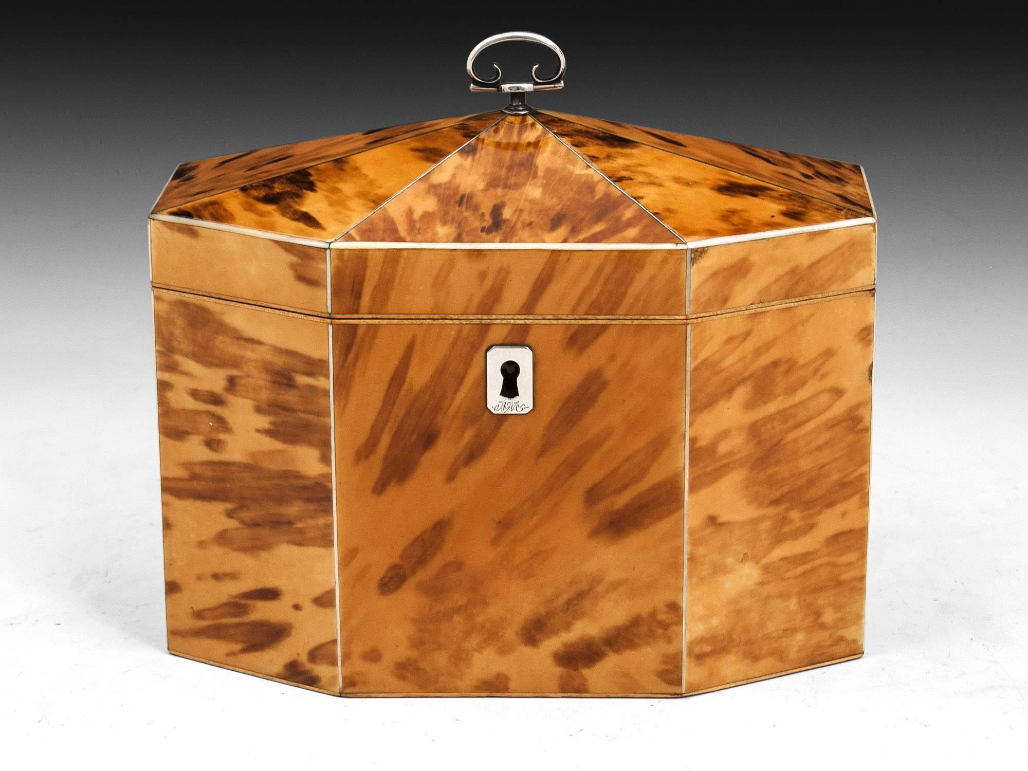 Exquisite blonde tented top tortoiseshell tea caddy with bone edges and stringing. The top features a beautiful sterling silver handle.

The interior features two tortoiseshell lids with bone handles and still contains traces of its original foil
