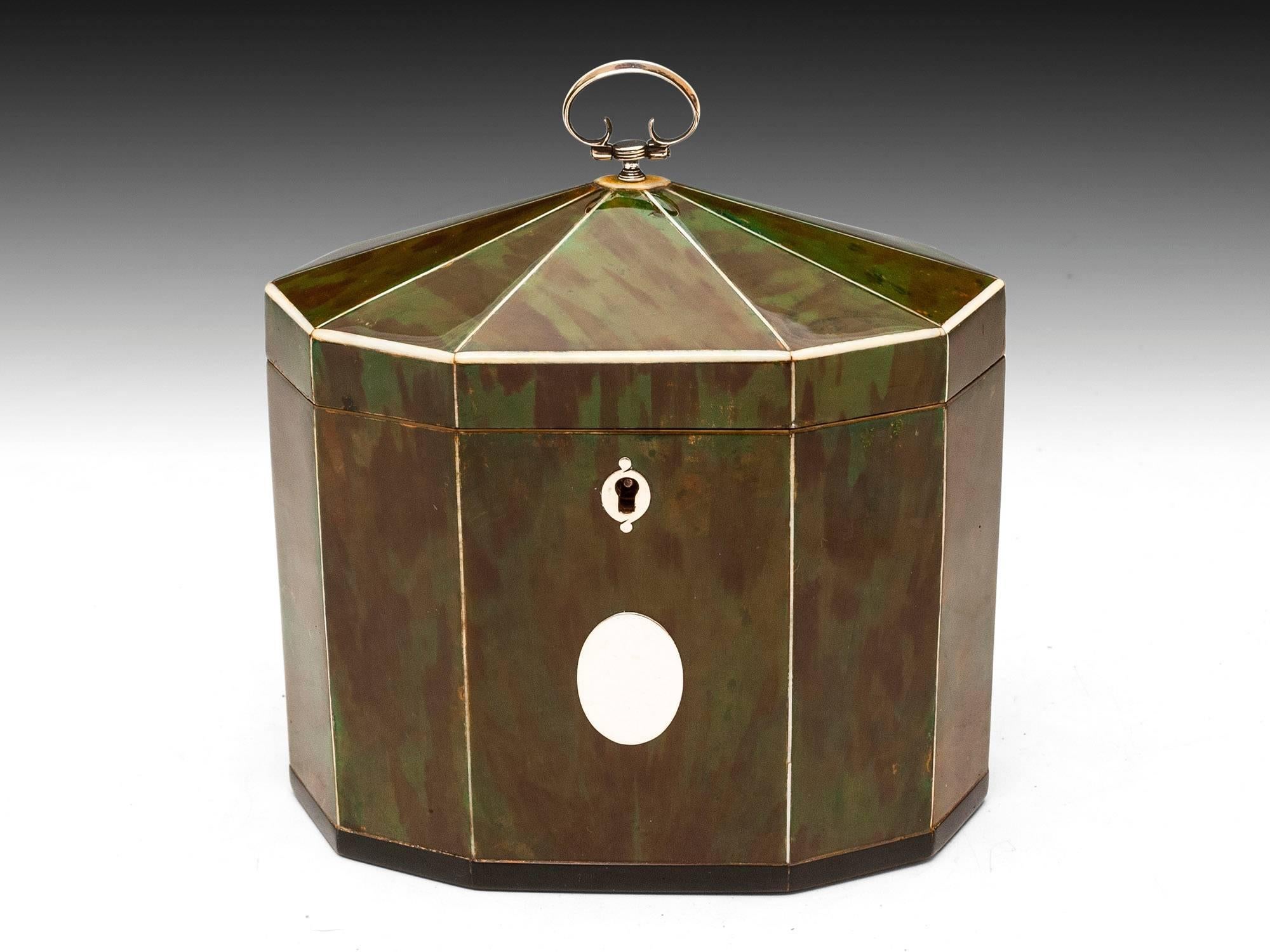 Rare decagonal tent top tea caddy with a deep green hue, separated by contrasting stringing. Horn lipped base, vacant silver initial plate, escutcheon, hinge and pull handle. The interior comprises two compartments with bone-handled green
