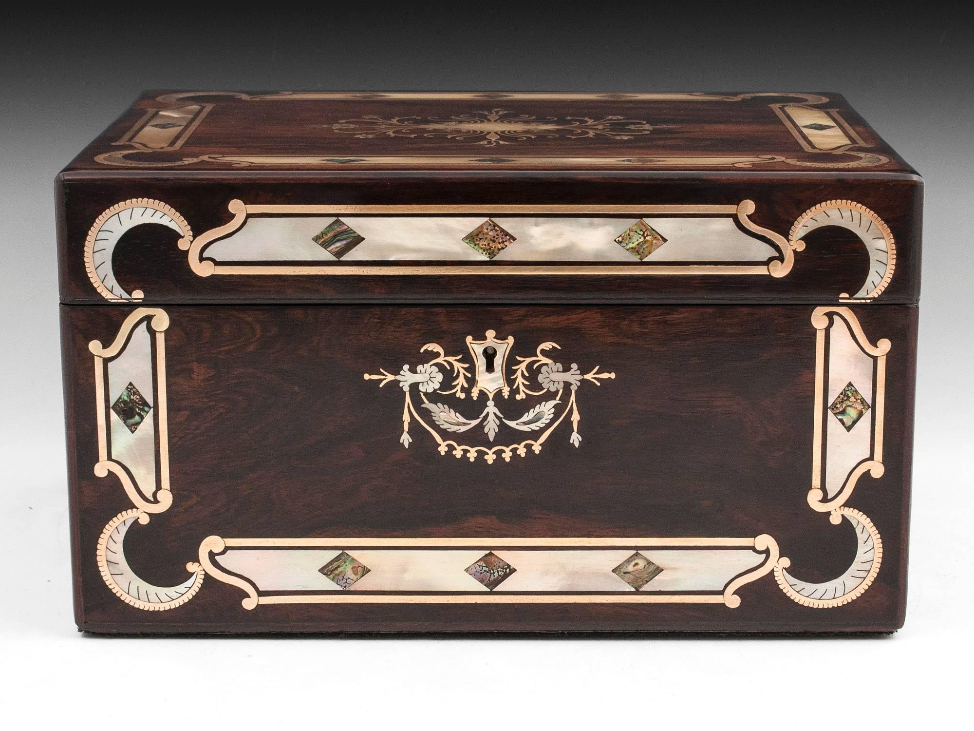 Exquisite antique rosewood jewelry box with inlaid mother-of-pearl with abalone diamonds framed with thick strips of brass. The escutcheon and initial plate have intricate floral inlay and delicate swags of brass, mother-of-pearl and Abalone.

The