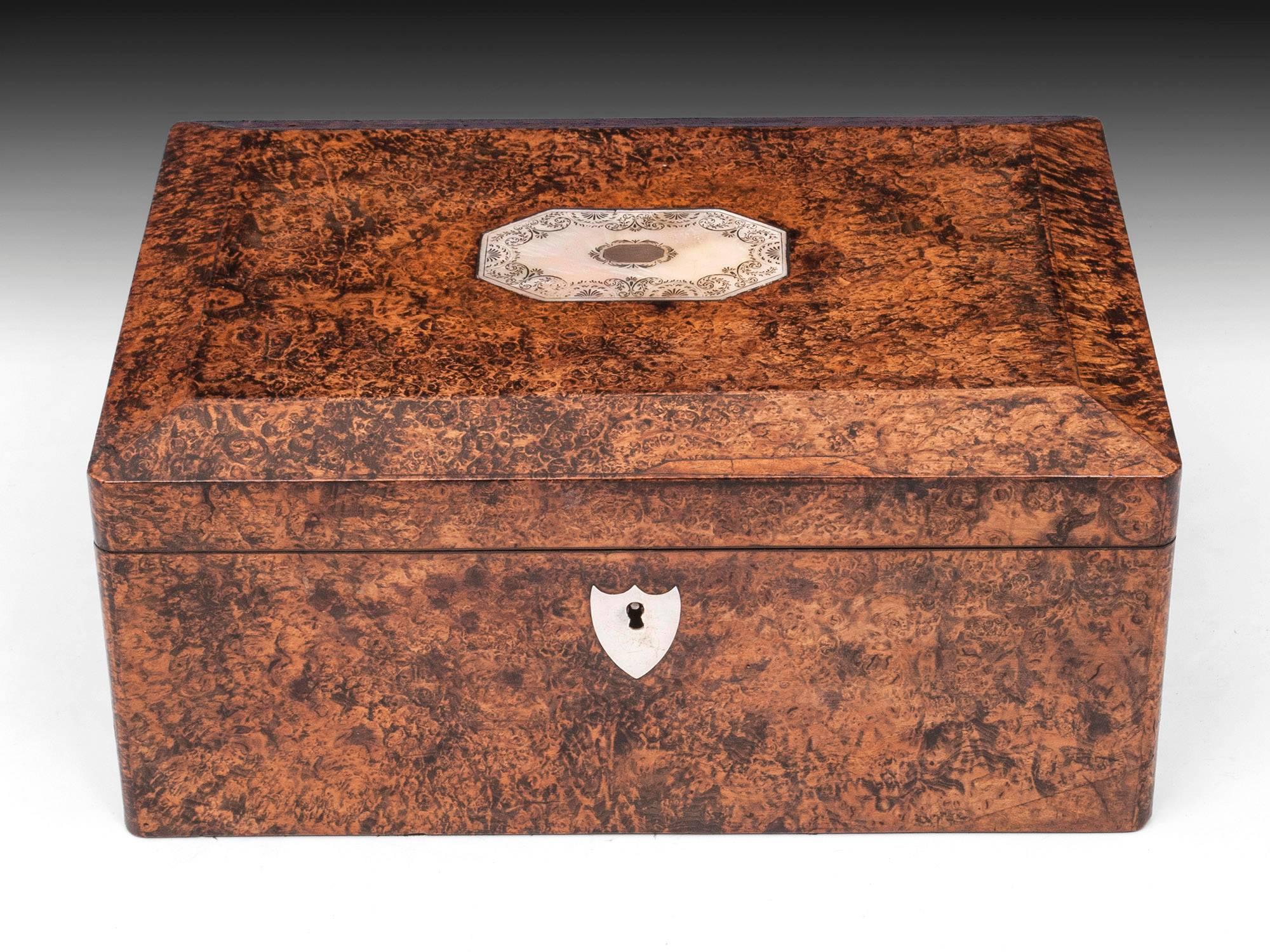 A lovely, outstanding quality fully-fitted mid-19th century French “Palais Royal” combination sewing, writing, vanity and tea box. Veneered in rare mulberry wood with canted top and inlaid engraved mother-of-pearl to the lid, with a shield-shaped