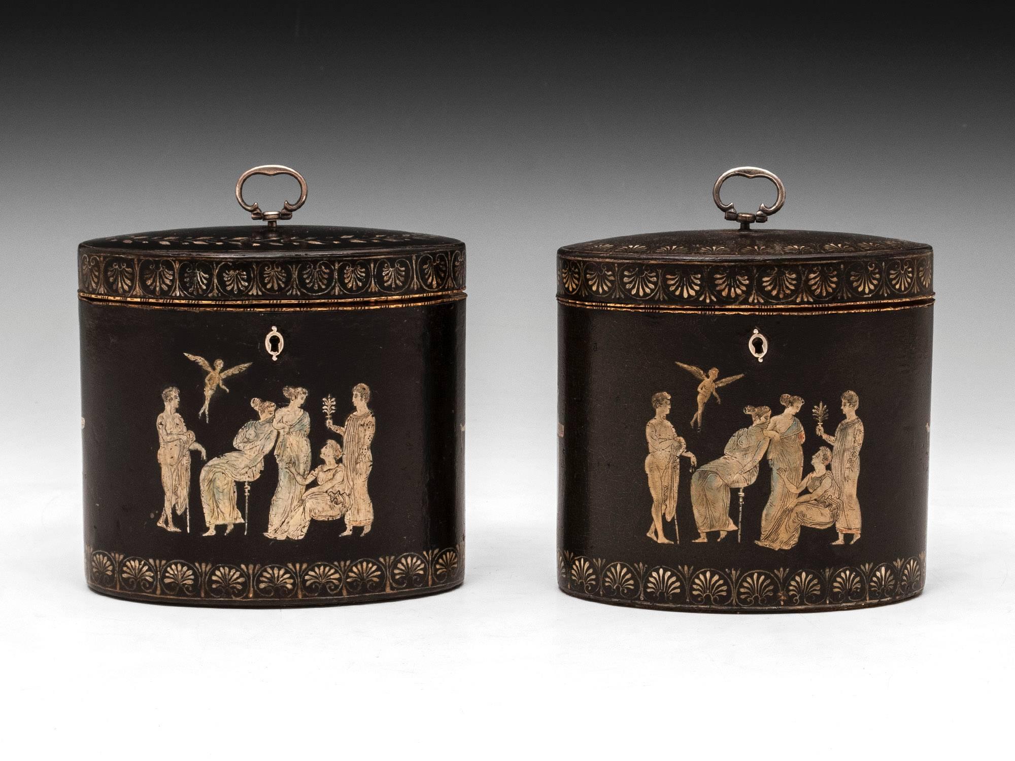 A rare pair of George III papier mache oval tea caddies, attributed to Henry Clay. Decorated using the grisaille method, with classical figures in the Etruscan style. Each caddy is decorated with bands of classical anthemions, one has a chevron