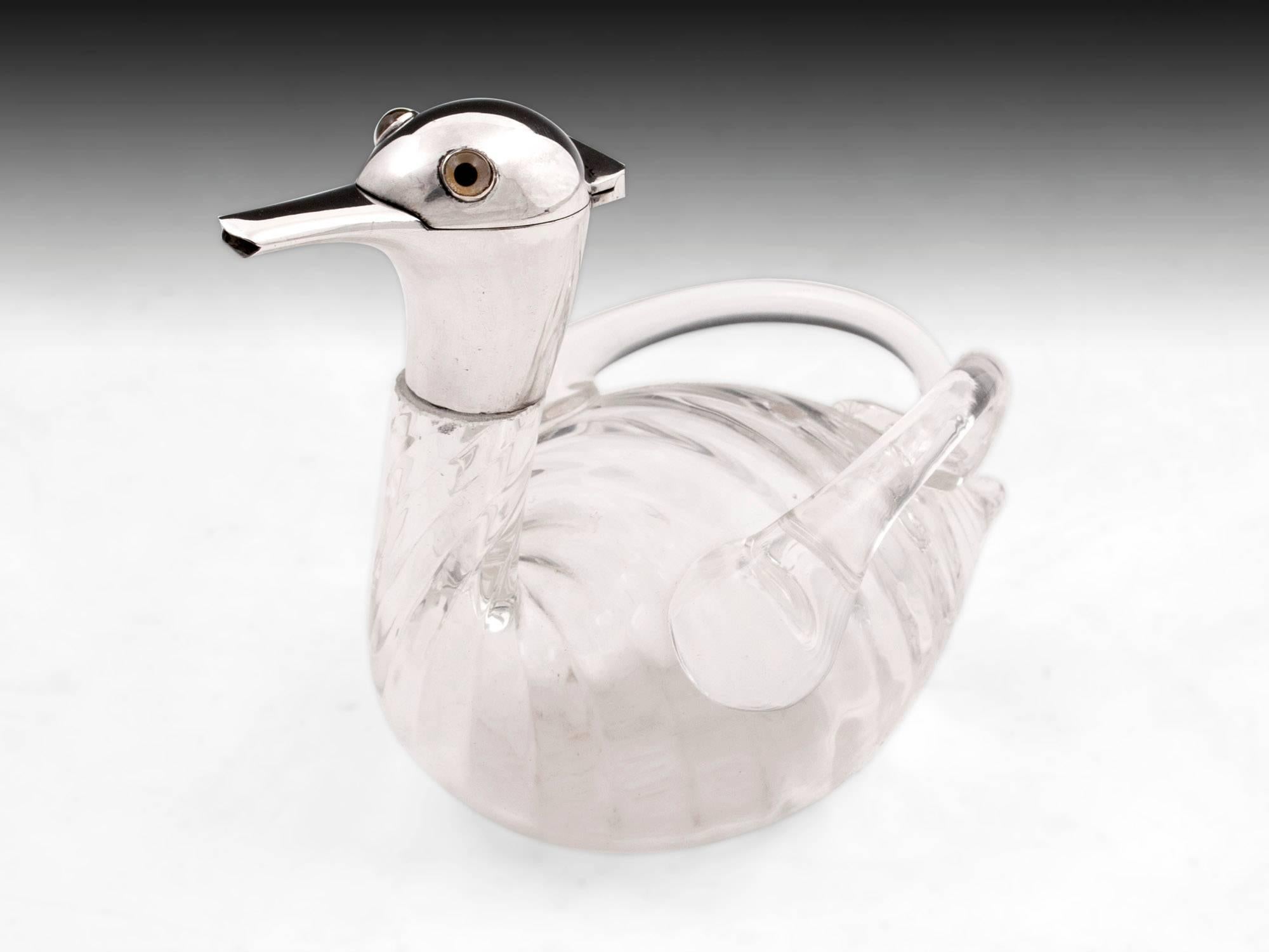 Charming miniature spirit decanter in the form of a duck with beautiful ribbed glass. Featuring continental silver head, hallmarked with the post 1888 German standard with realistic glass, coloured eyes. Retailed by Francis Meli, Malta. 

The head