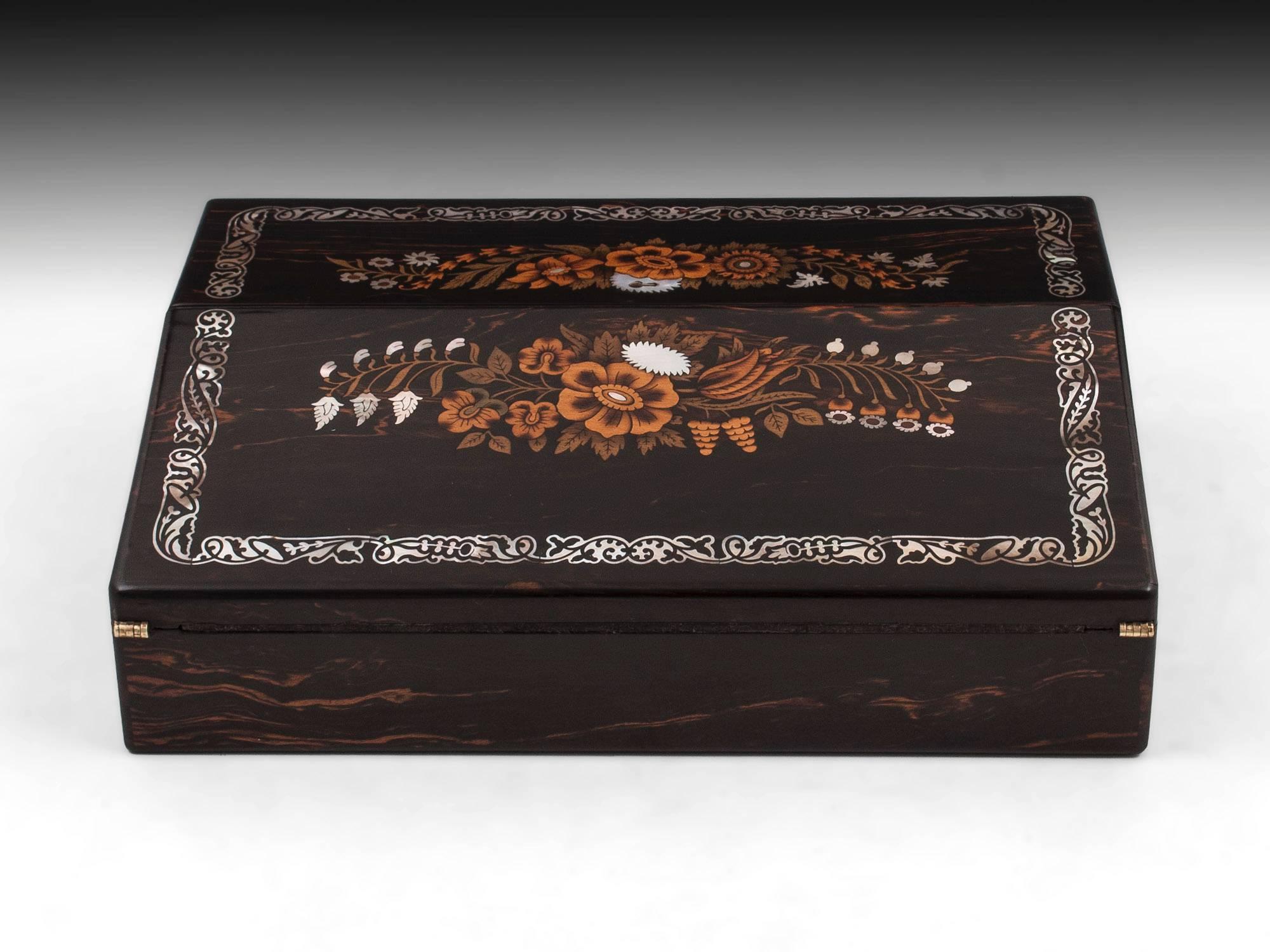 Coromandel and satinwood writing box with beautiful floral inlays comprising of mother-of-pearl and boxwood. 

On opening this exquisite antique writing slope it reveals a dark green leather writing surface with gold tooling. The top half of which