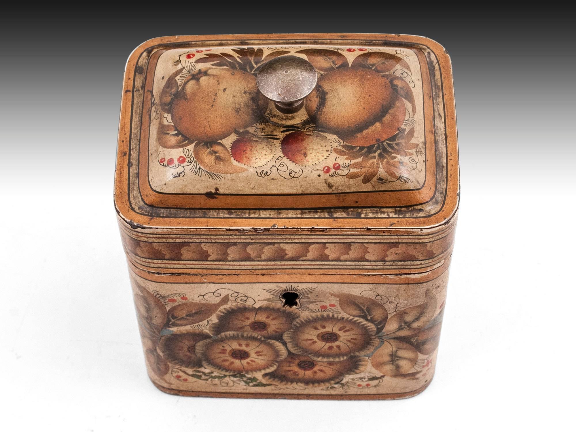 (This tea caddy is currently on display at  “A Tea Journey: from Mountain to the Table” at Compton Verney until the 22nd september.)
Toleware Tea caddy decorated with beautiful floral designs with blue ribboned swags and bold stripes of gold, black