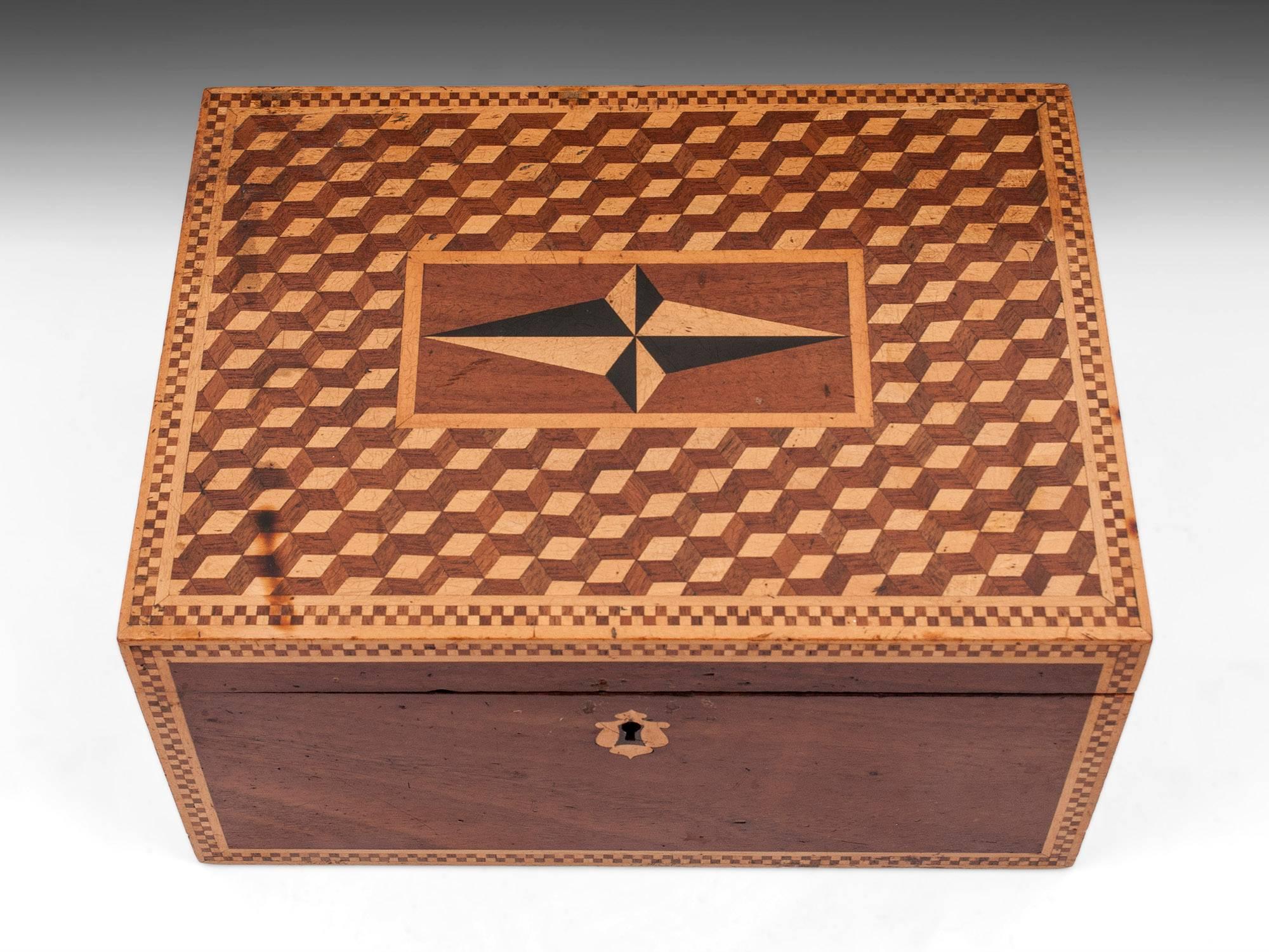Antique box made of mahogany with an interesting cube perspective design on the top with a four point nautical star in the center.

The interior is lined with black leather paper and purple velvet.

The exterior shows signs of age and has one or
