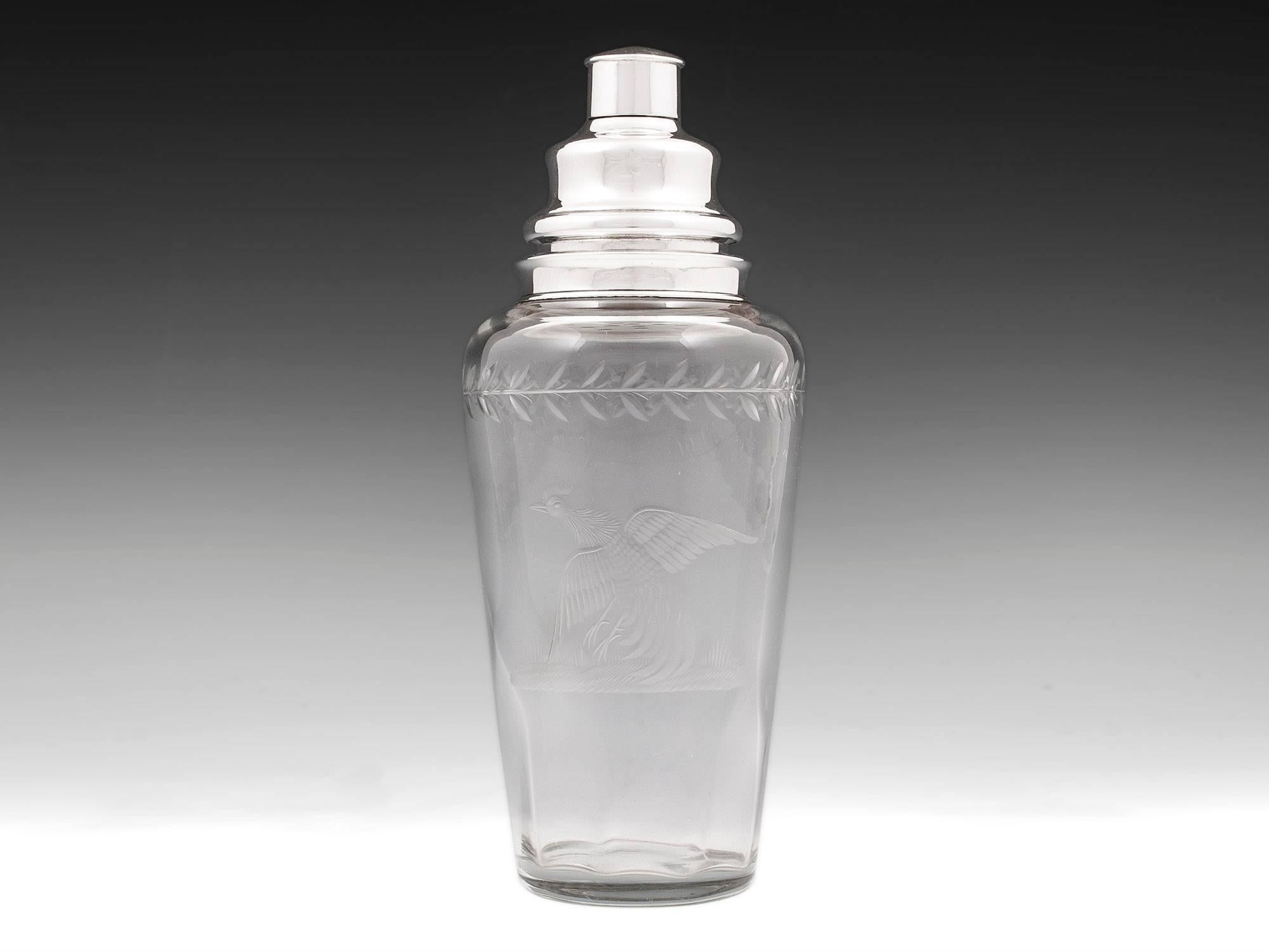 Interesting sterling silver cut-glass cocktail shaker with a tapered glass body engraved with a superb cockerel with foliage top border.

Each component of the silver cocktail Shaker is marked Sterling. The bottom and a quarter of the way up the