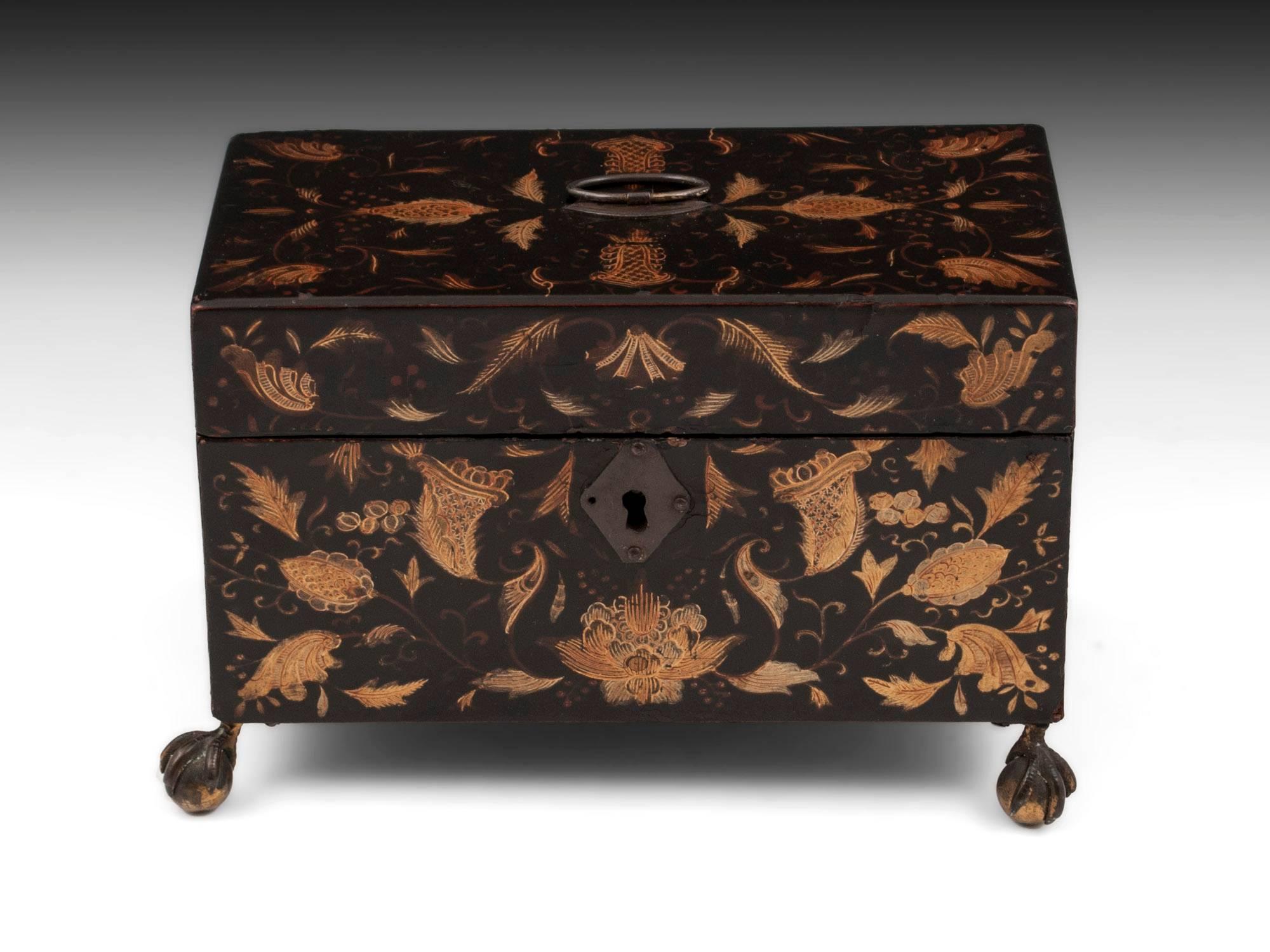 Lacquer tea chest with beautiful gold floral inlays on all sides with brass handle and escutcheon. Standing on four brass ball and claw feet. 

The interior contains two removable tea caddies with sliding lids, each adorned with conch shells and
