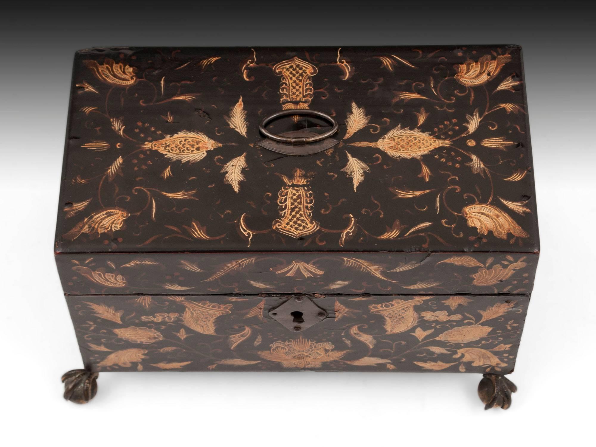 Lacquer tea chest with beautiful gold floral inlays on all sides with brass handle and escutcheon. Standing on four brass ball and claw feet. 

The interior contains two removable tea caddies with sliding lids, each adorned with conch shells and