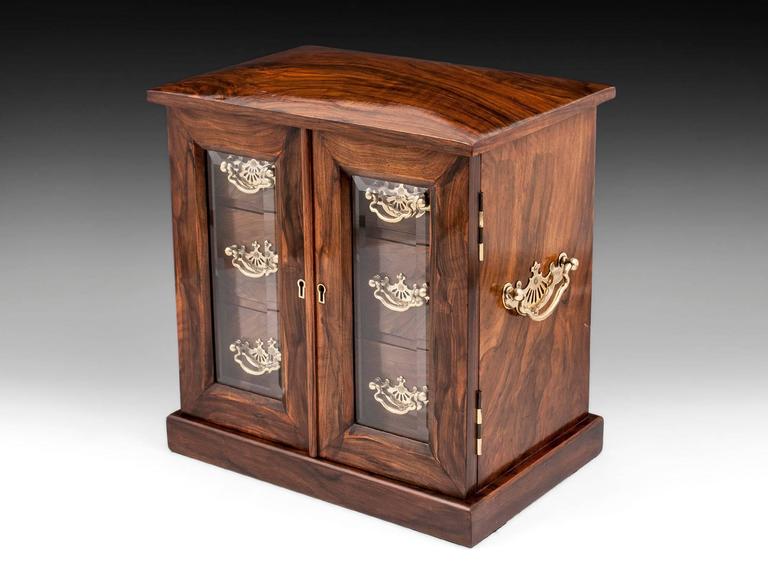 Antique Glazed Jewelry Cabinet Of Feathered Walnut And Brass For Antique jewelry cabinet veneered in feathered walnut with glazed doors and ornate pierced brass swing handles - Antique Glazed Jewelry Cabinet Of Feathered Walnut And Brass For