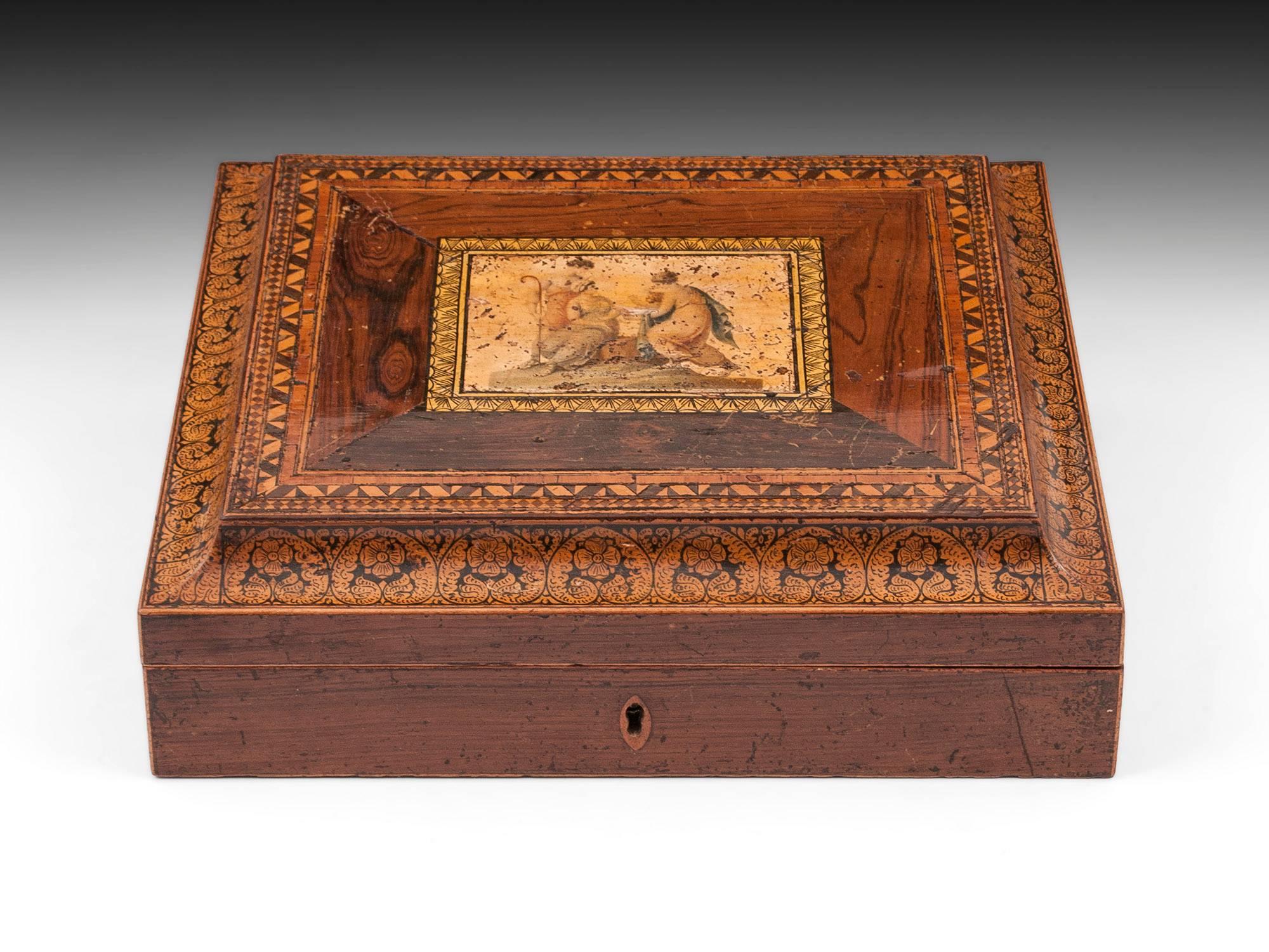 Antique writing box. The top has a penwork border and is adorned with a beautiful colored print depicting "infant Bacchus delivered to Nymphs on Mount IDA".

The interior of this early writing slope is lined with pink paper and features