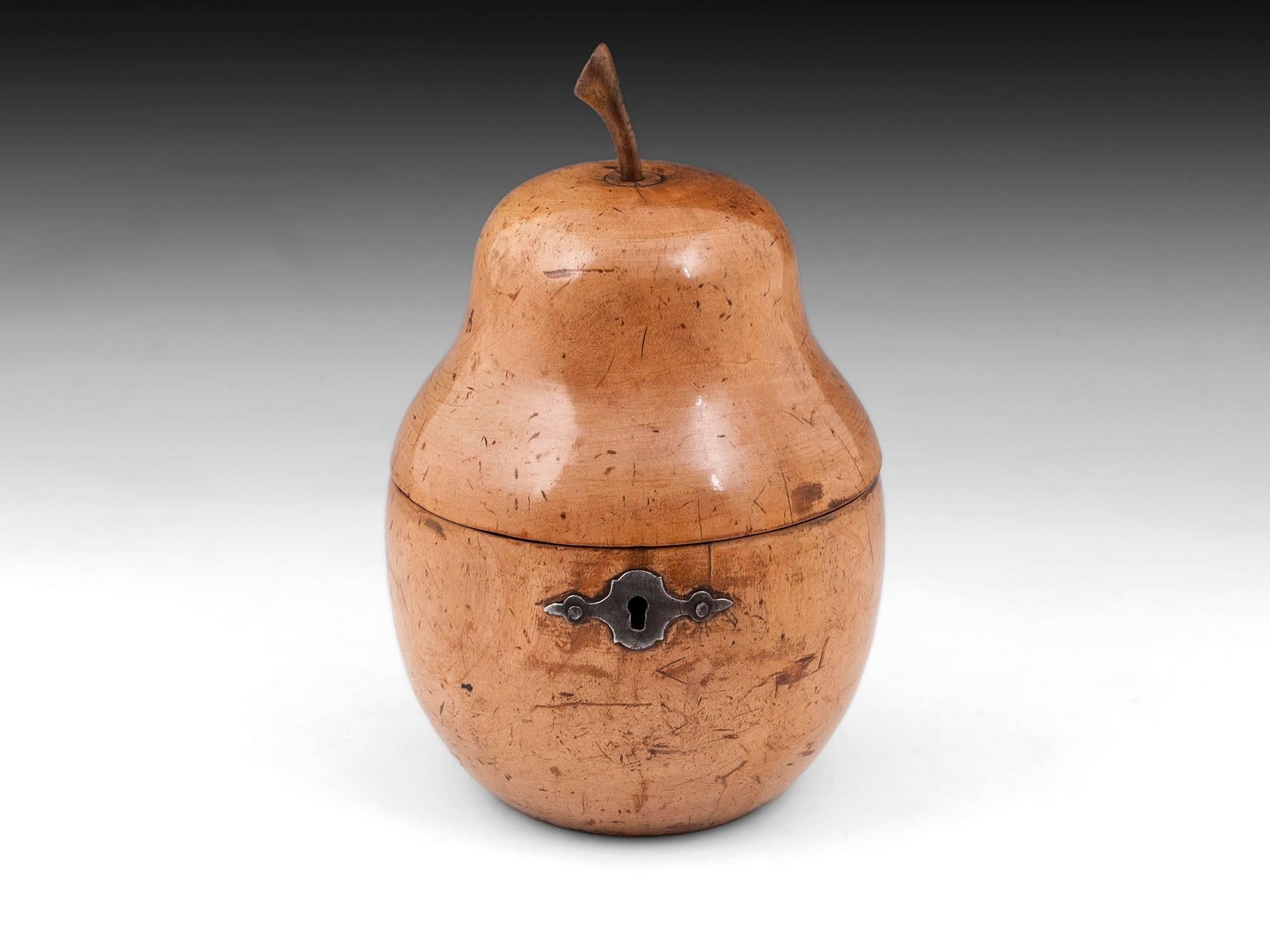 Antique pear tea caddy with wonderful realistic pear shape, has beautiful colour and wonderful patination. The Pear has a wooden stalk, has steel lock and shaped escutcheon. 

The interior of this treen pear still has traces of its original lining
