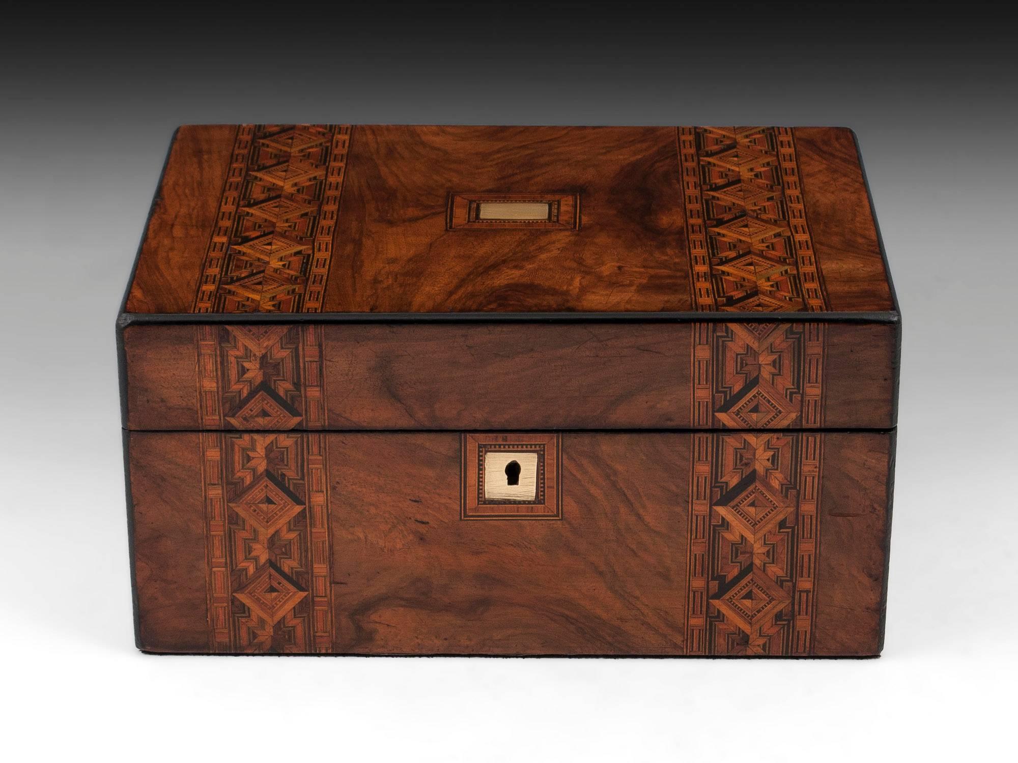 Antique walnut Tunbridge style jewelry box with decorative bands running over the top and front with vacant brass initial plate and escutcheon. 

The Tunbridge style jewelry box interior has a green water silk paper lining and green velvet and