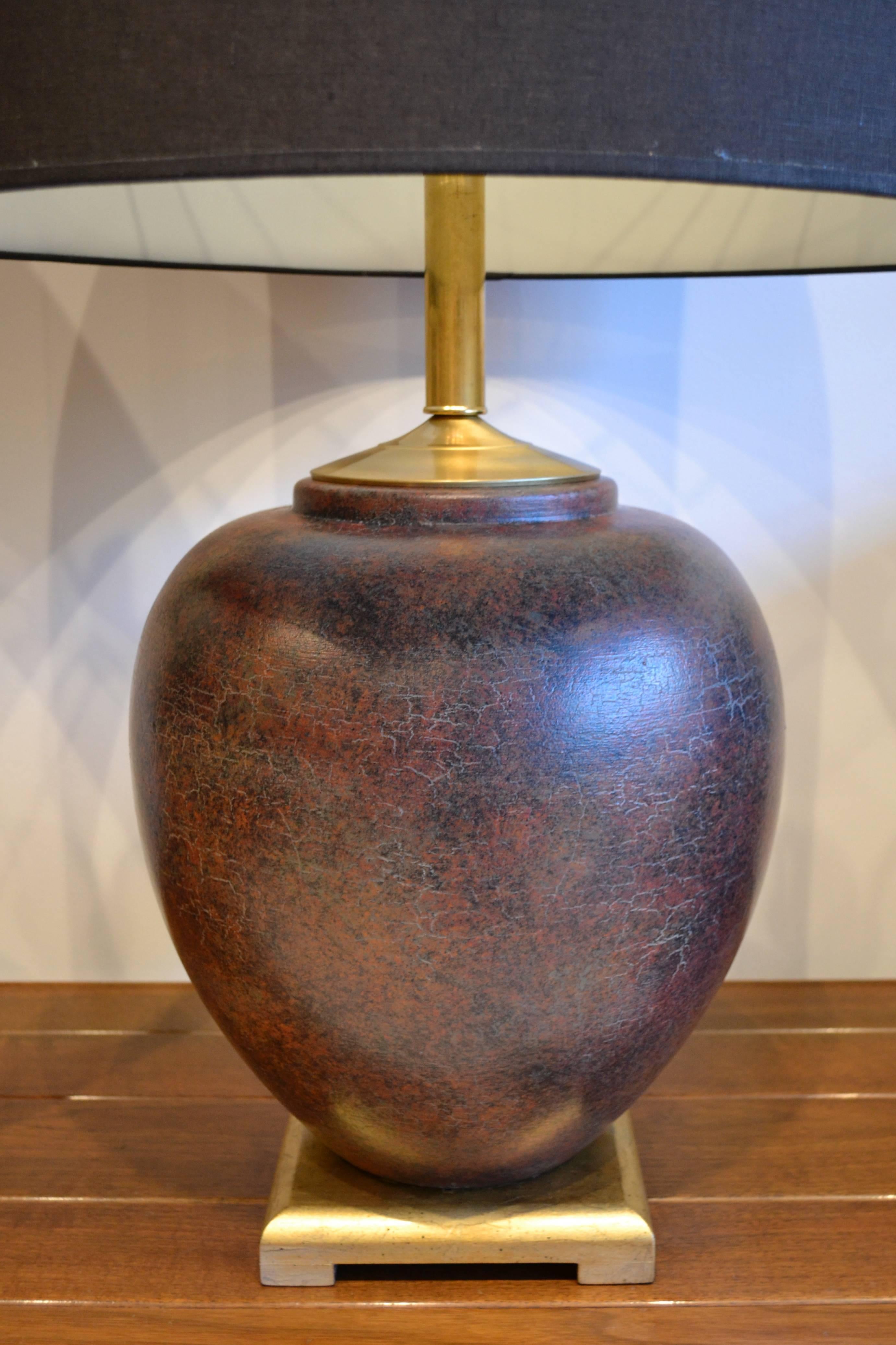 Very large pair of Asian ceramic table lamps with all solid brass components. Burnt rust color ceramic ginger jar mounted on gilded wooden bases. Stunning. See close-ups for color. Very similar to the work of James Mont.