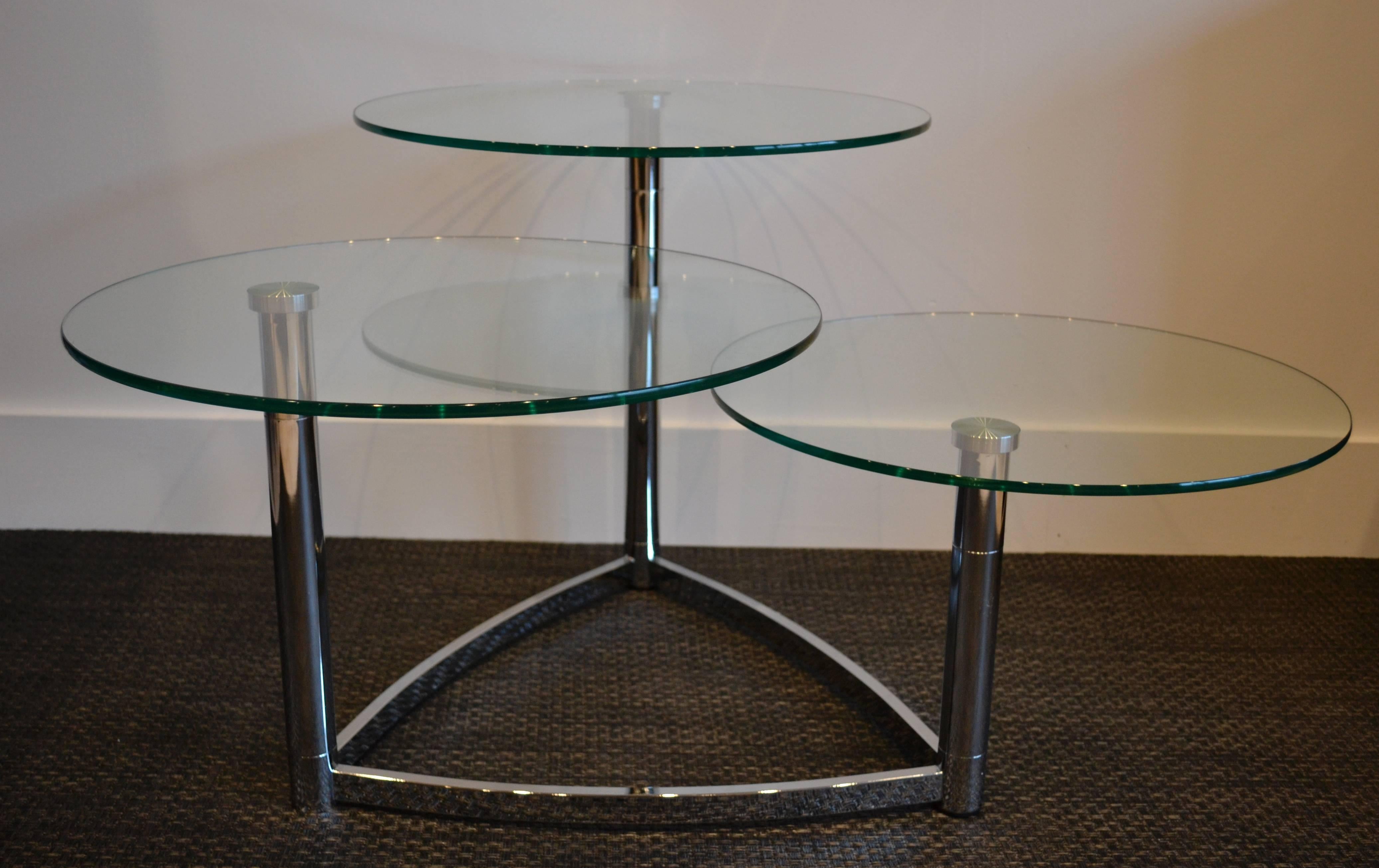 chrome base coffee table with three tier round glass tops that rotate.